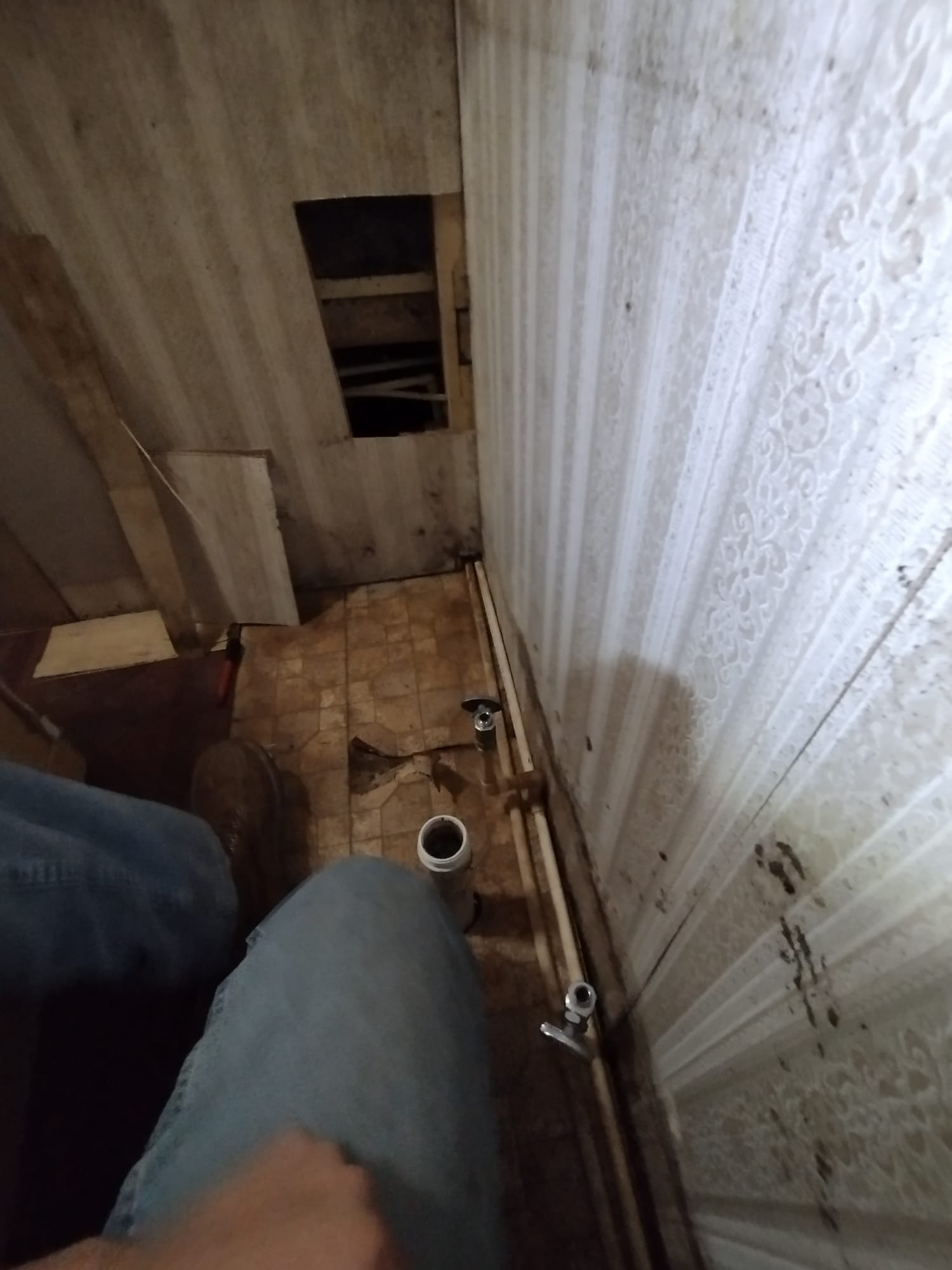 Image capturing a corner during active plumbing work, illustrating the ongoing repair efforts by our HEP technician