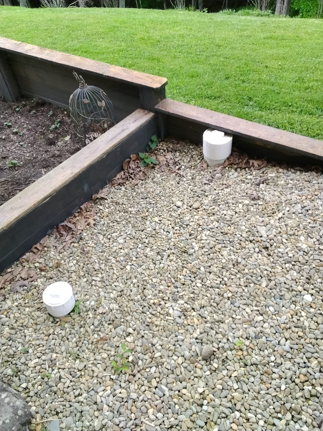Newly installed septic system access covers in a landscaped setting