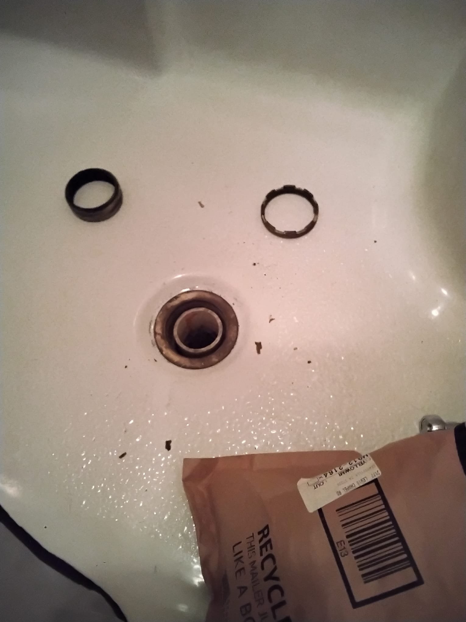 Before repair: worn shower drain components showing signs of wear and debris