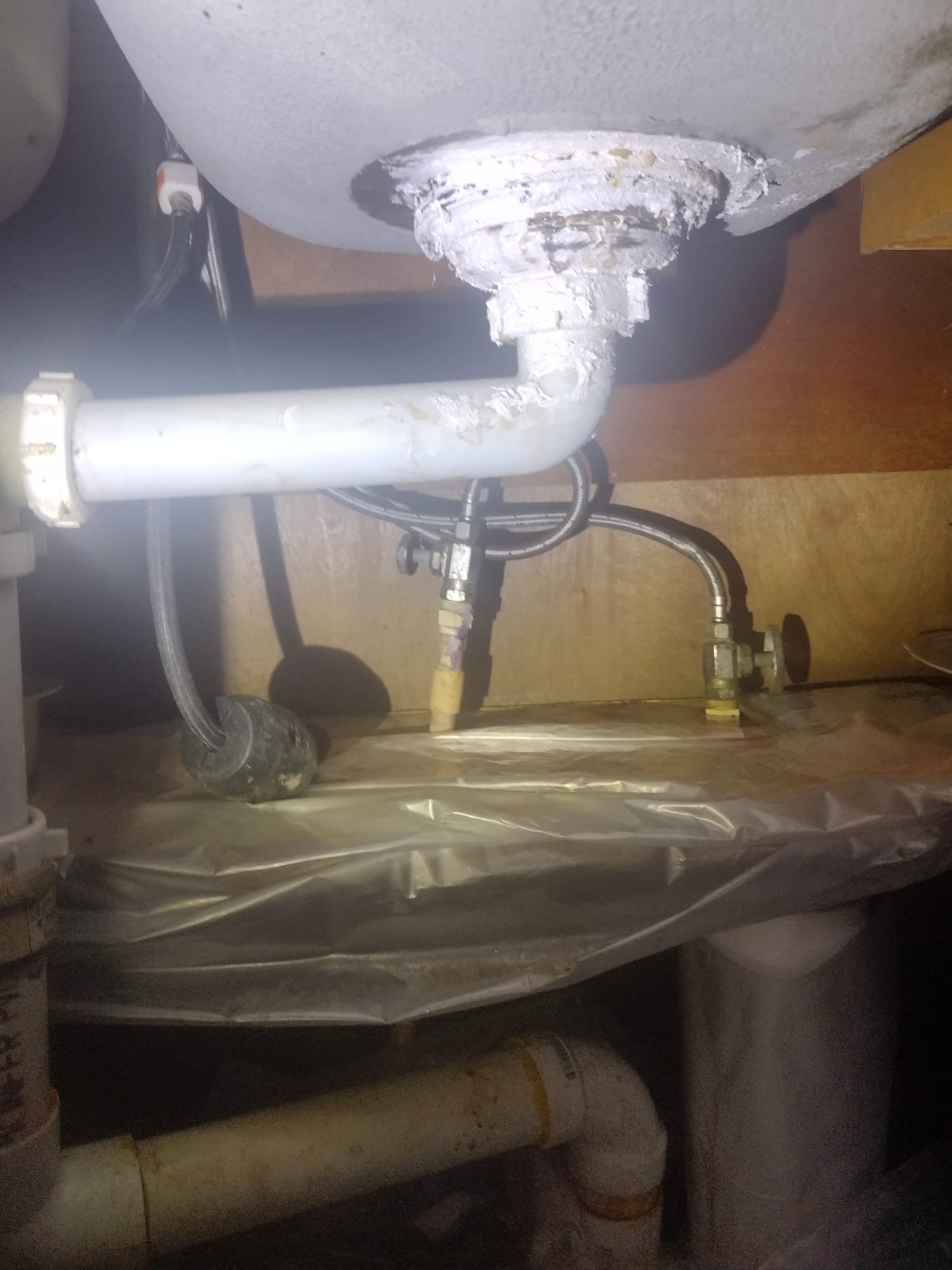 Before repair image: worn and corroded sink plumbing