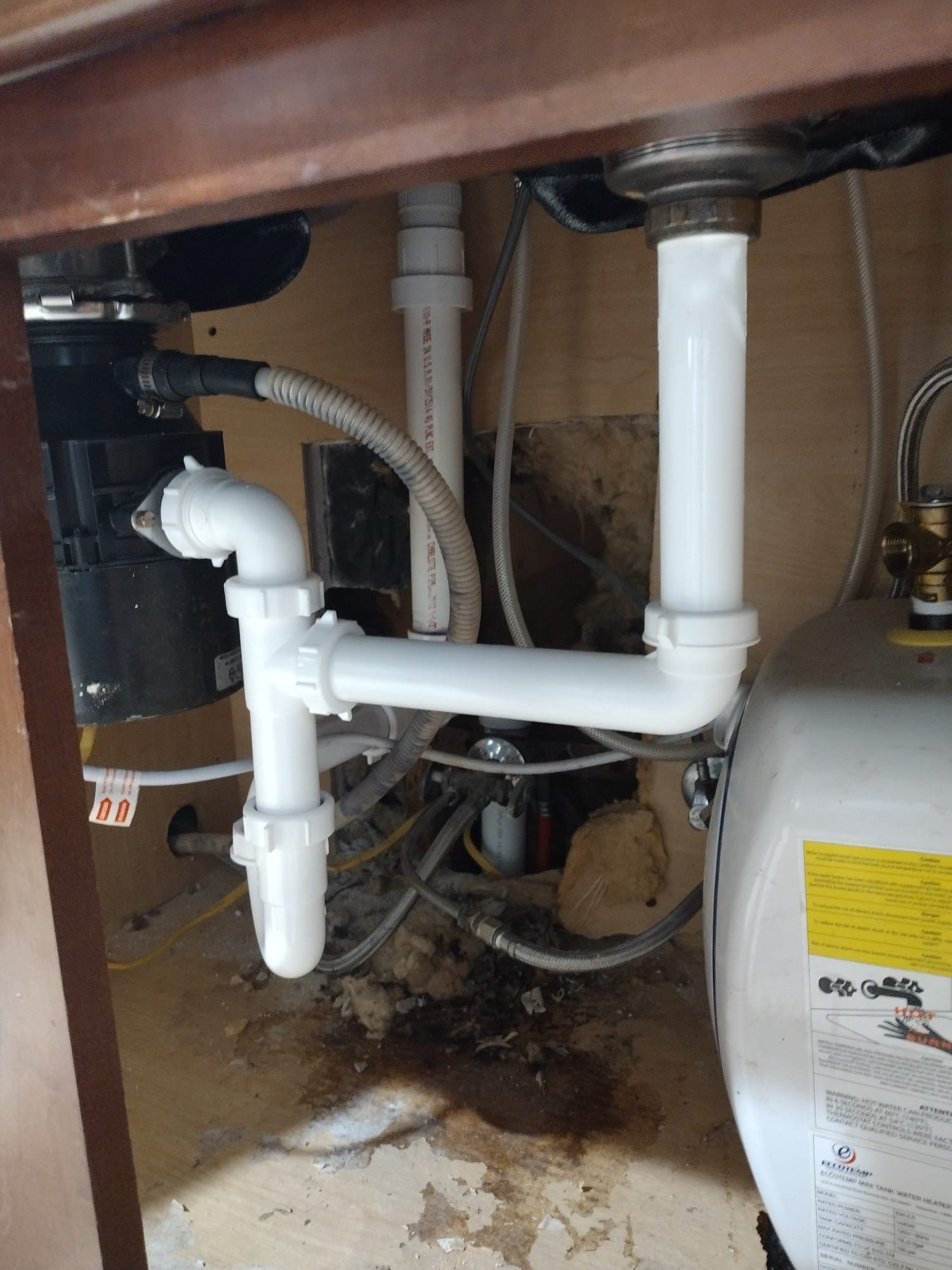 New PVC plumbing setup under a kitchen sink
