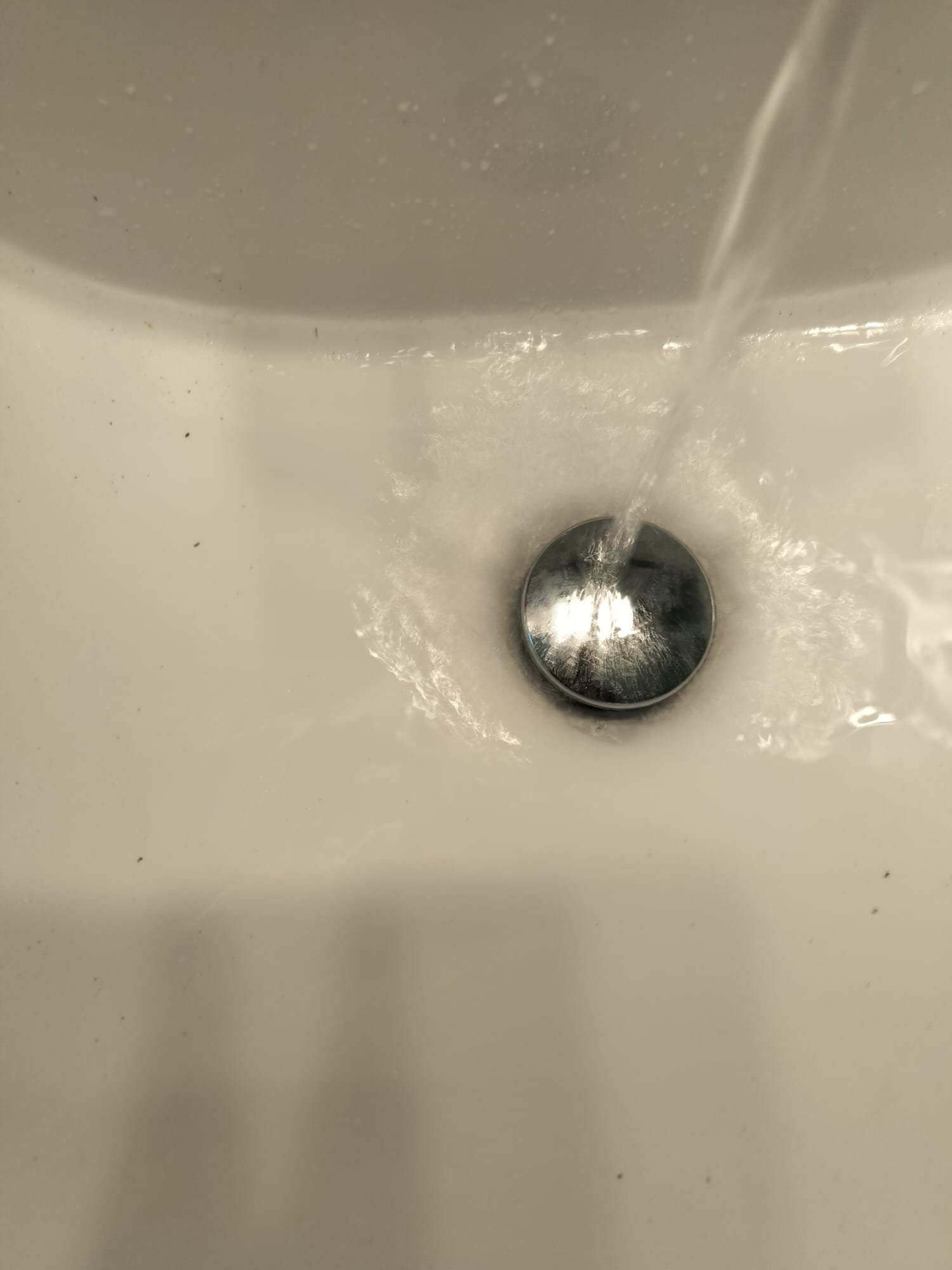 After the repair, the sink is functioning properly with water flowing smoothly