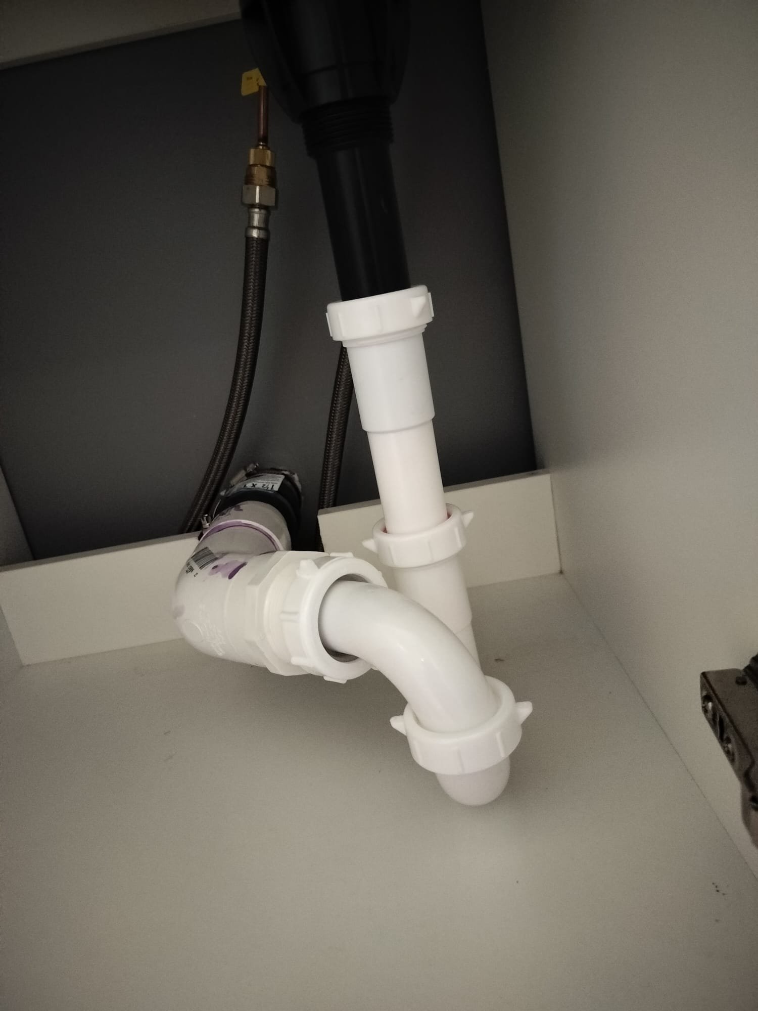The newly installed piping and secure connections showcase a modern plumbing setup