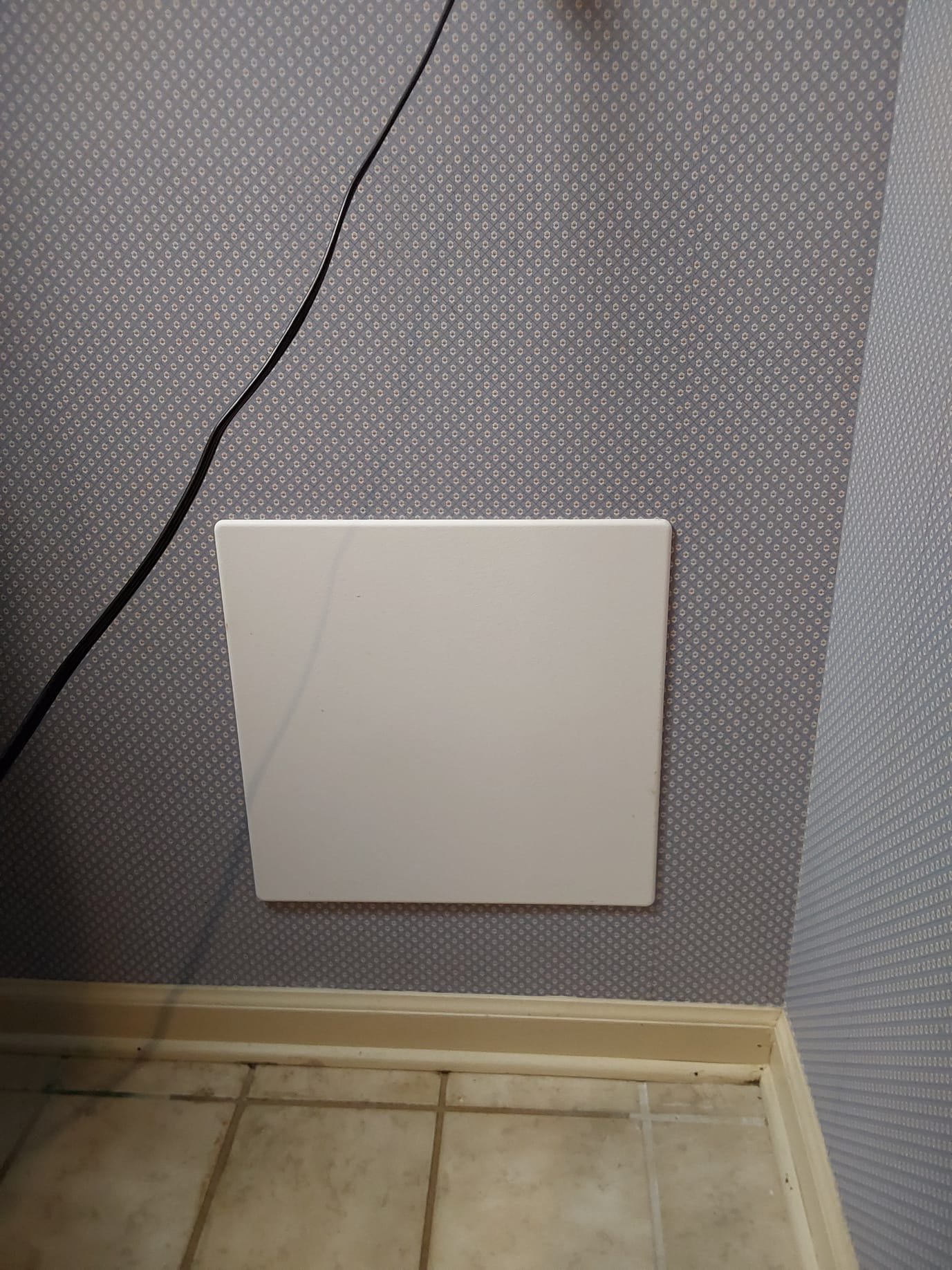 After Repair – A neat access panel now conceals the repaired plumbing