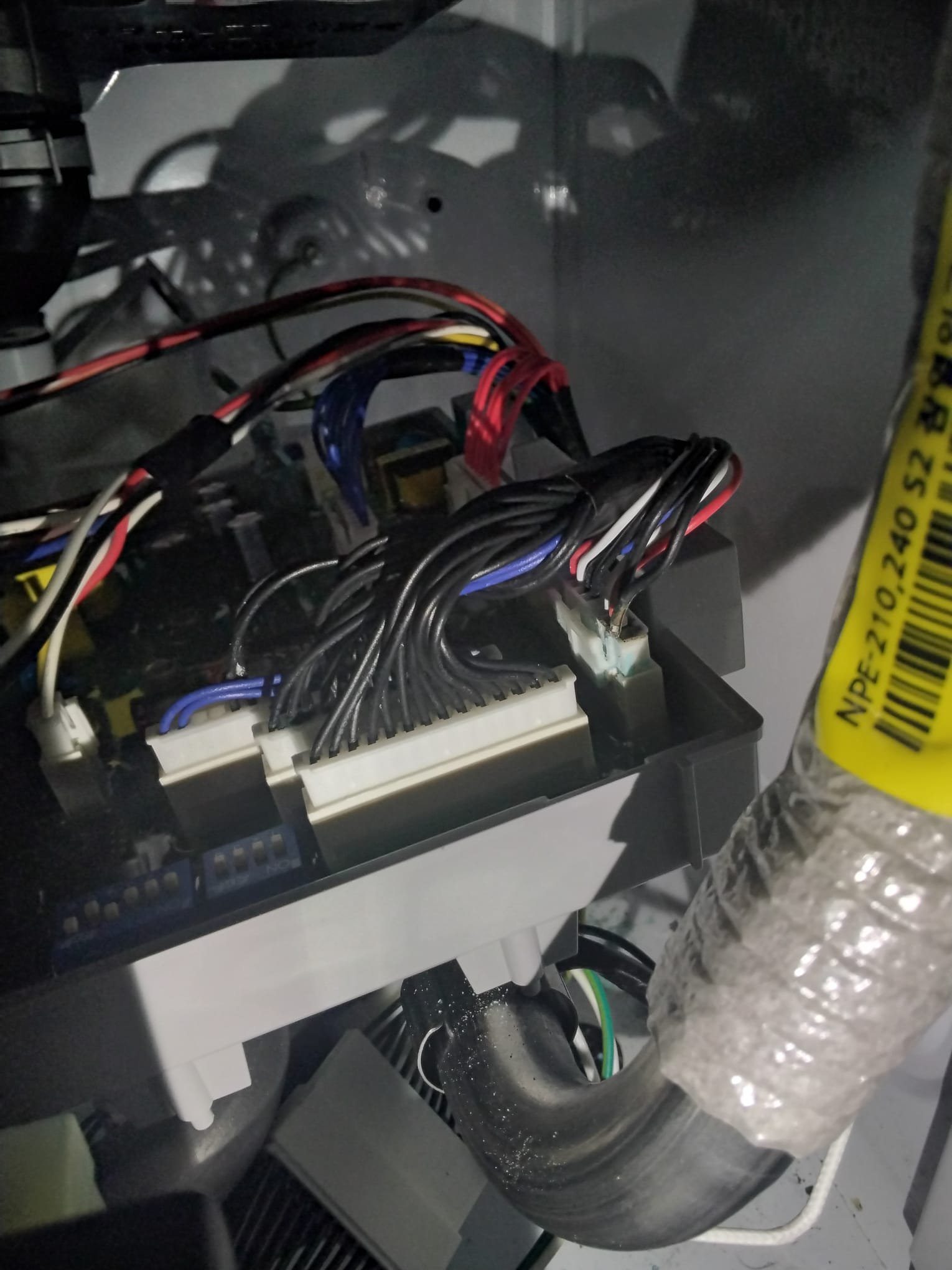 The interior wiring and components of a water heater, with secure connections after repair work