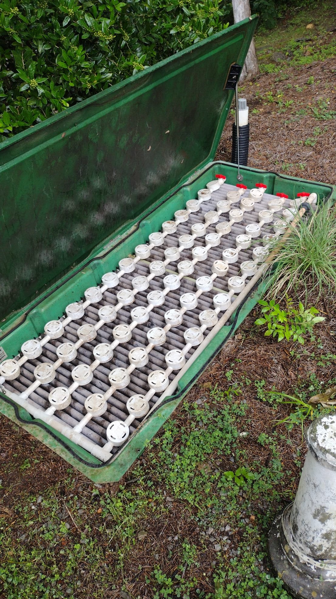 Septic system component with its lid open, showcasing a newly maintained state