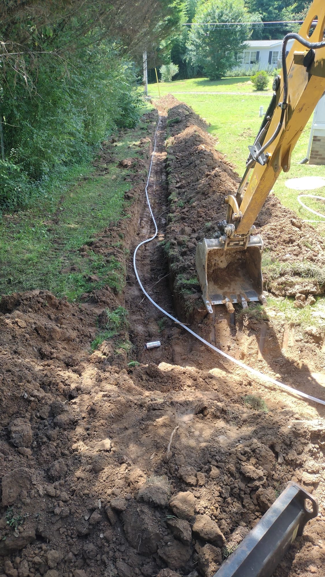 Trench excavation in progress, leading to new water line installation