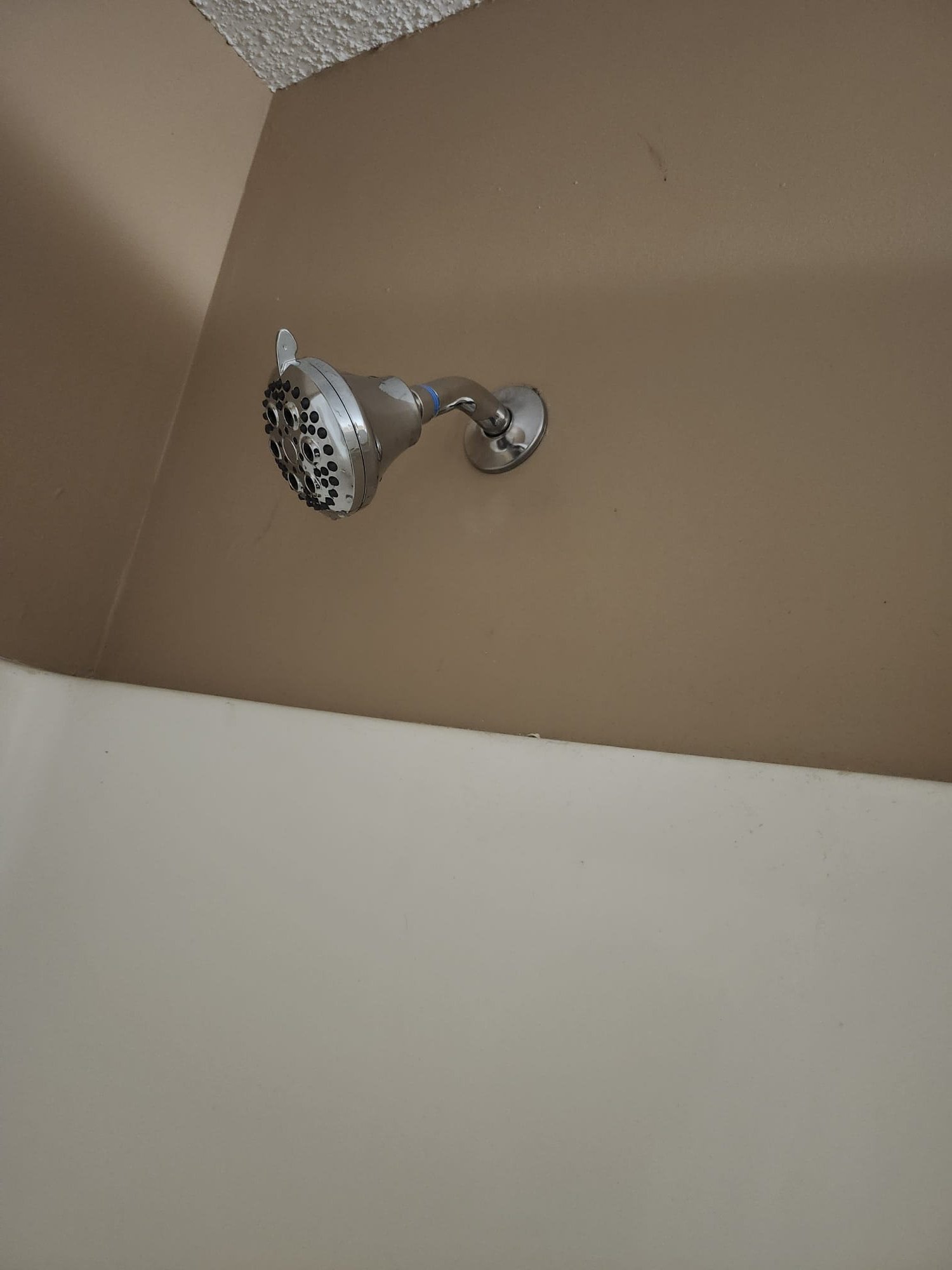 A modern, installed showerhead in a clean bathroom setting, representing an upgrade from previous fixtures.