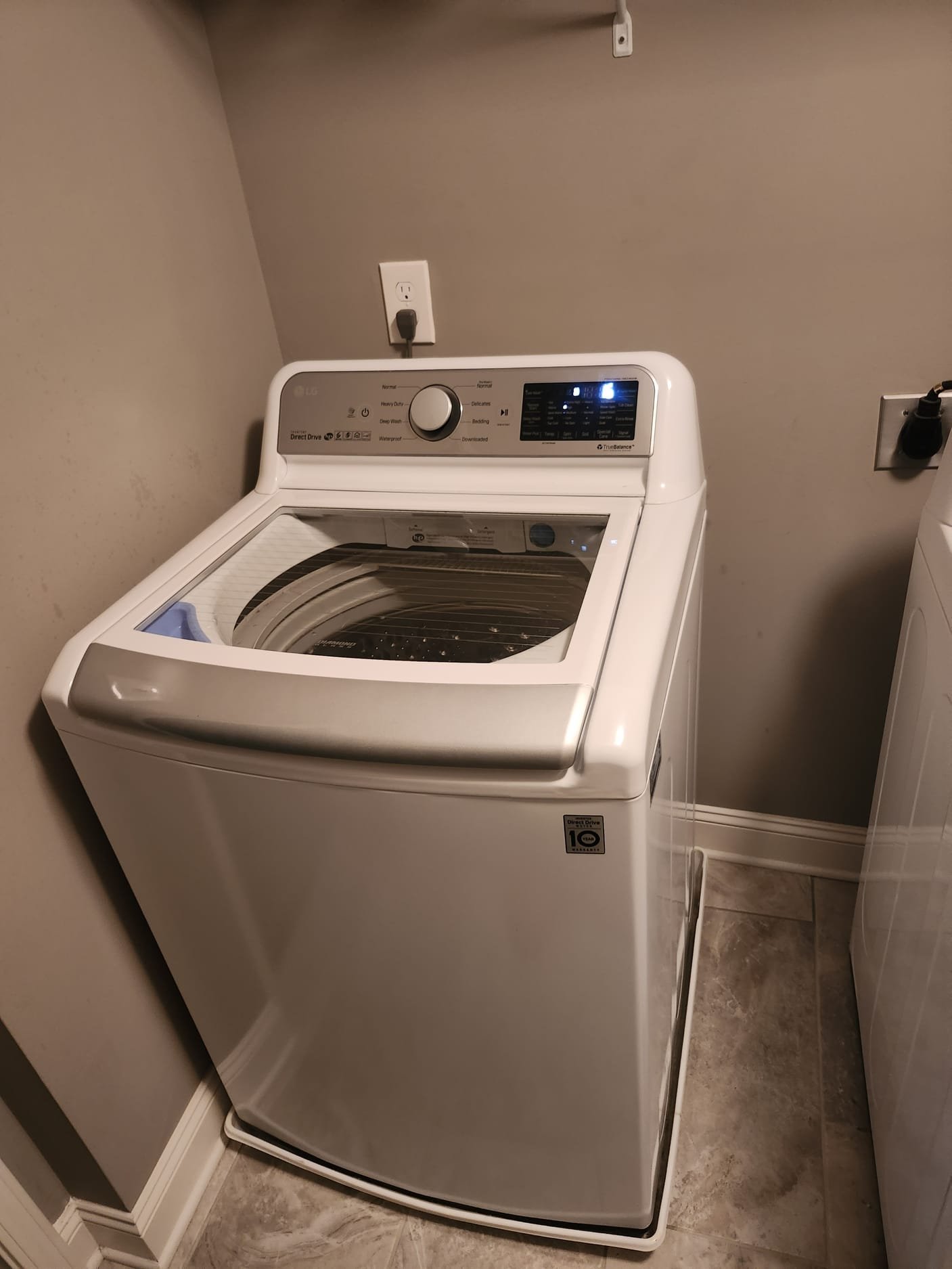 Modern top-loading washing machine in a clean laundry area
