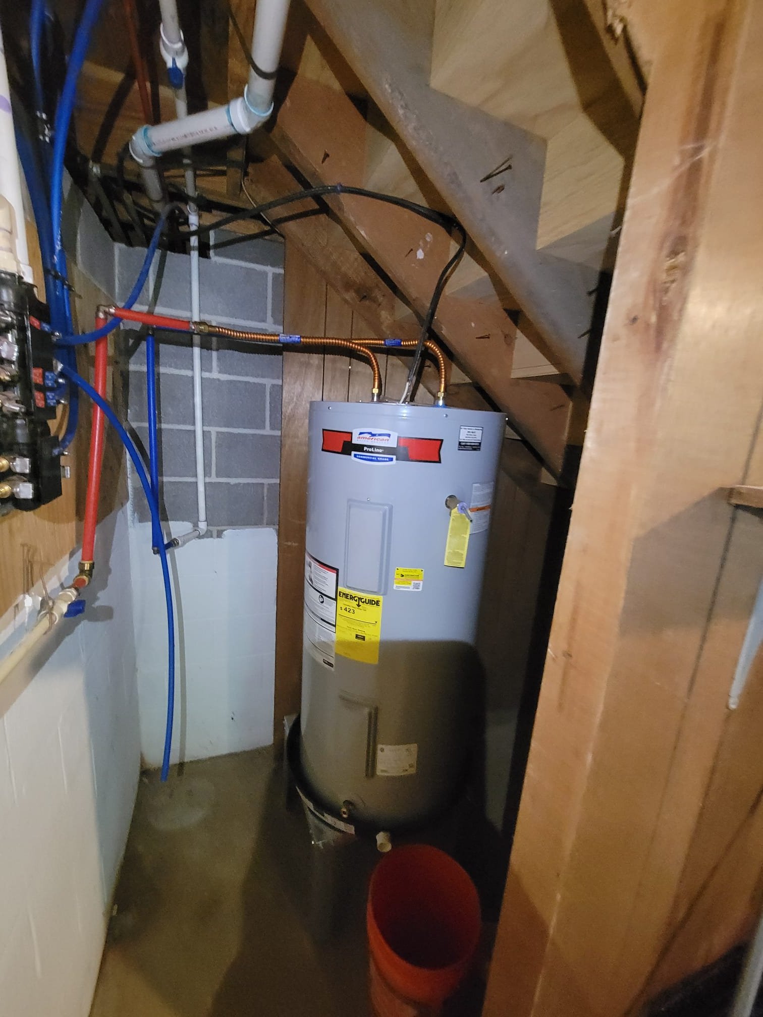 Newly installed water heater with proper piping and drain pan