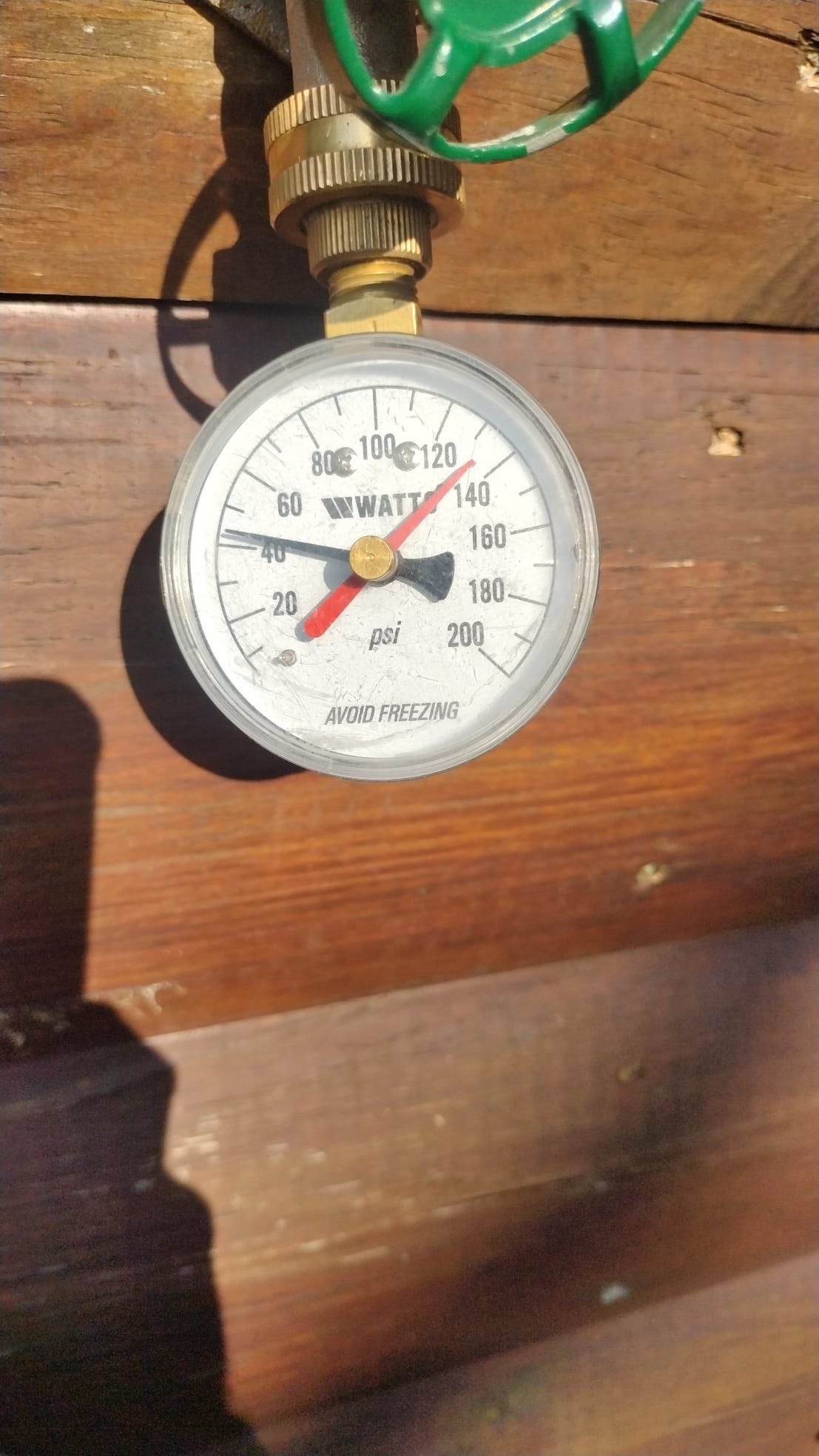 Pressure gauge showing water pressure reading.