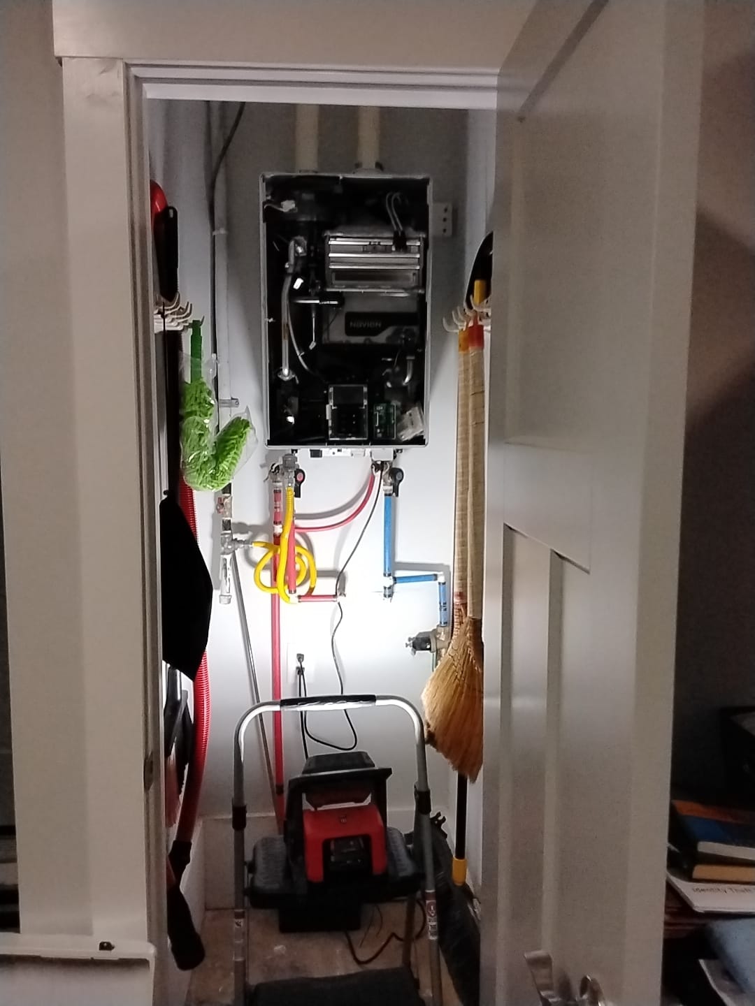 Well-organized utility closet with tankless water heater