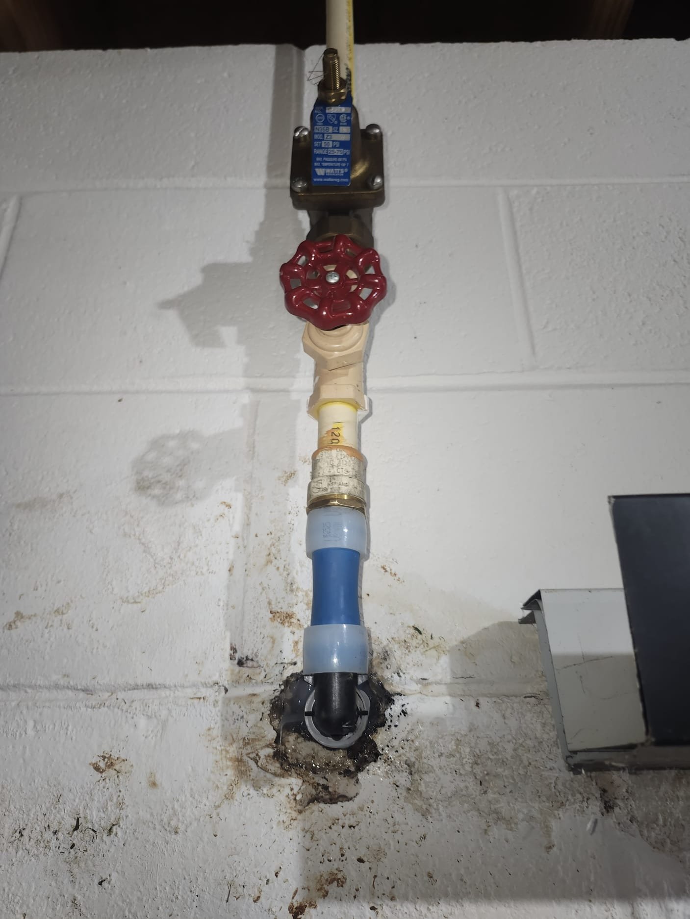 After Repair: Modern PEX shut-off valve mounted on foundation wall