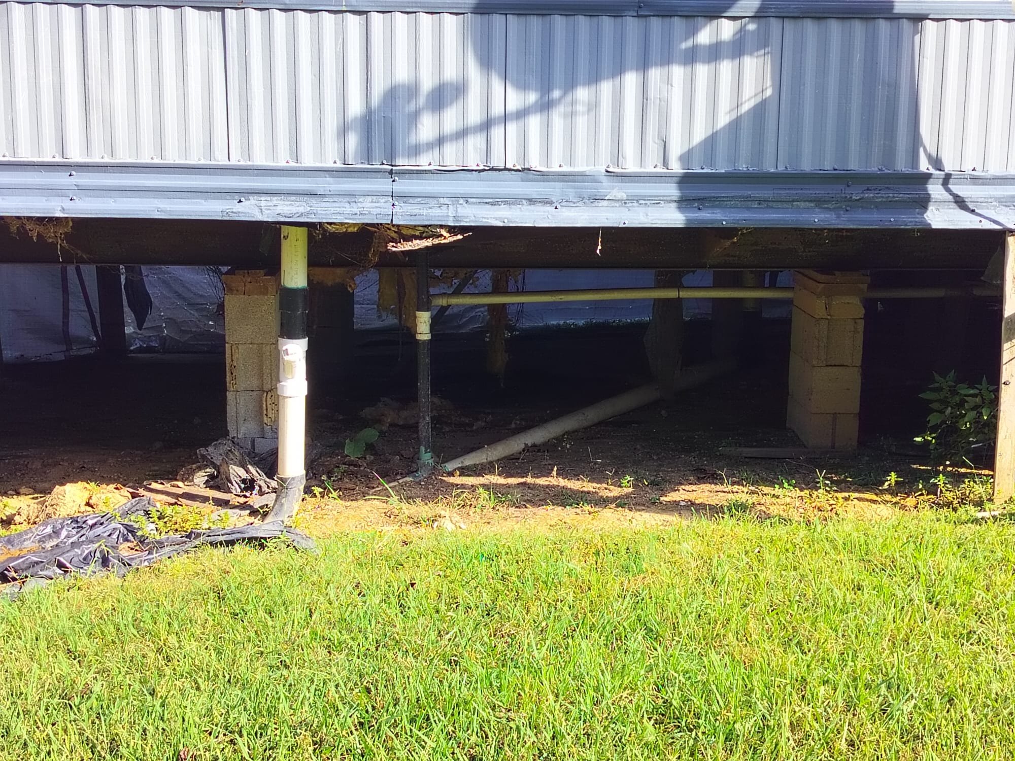 Under-home plumbing with new and old pipes