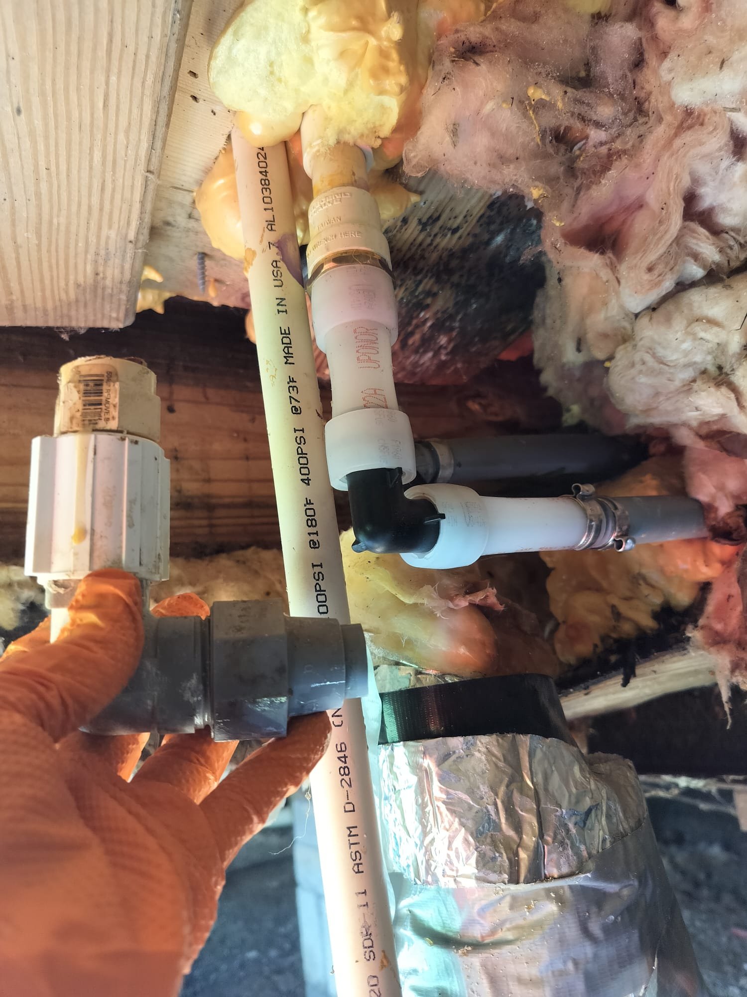 Technician holding old fitting next to new pipe