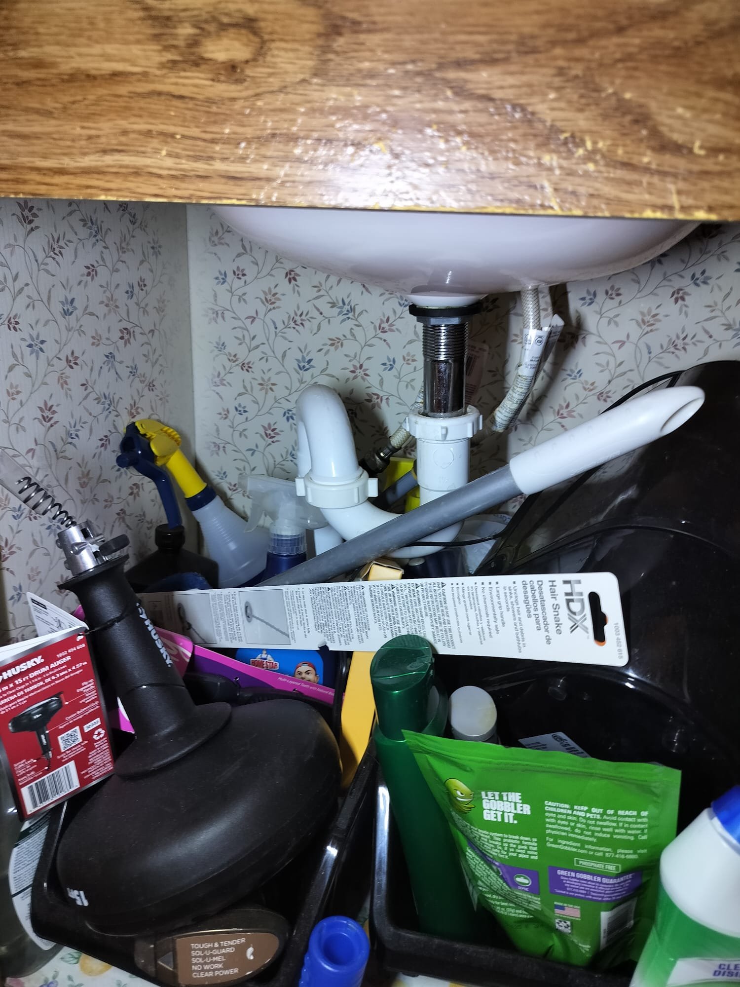 Under-sink area with new P-trap and plumbing tools