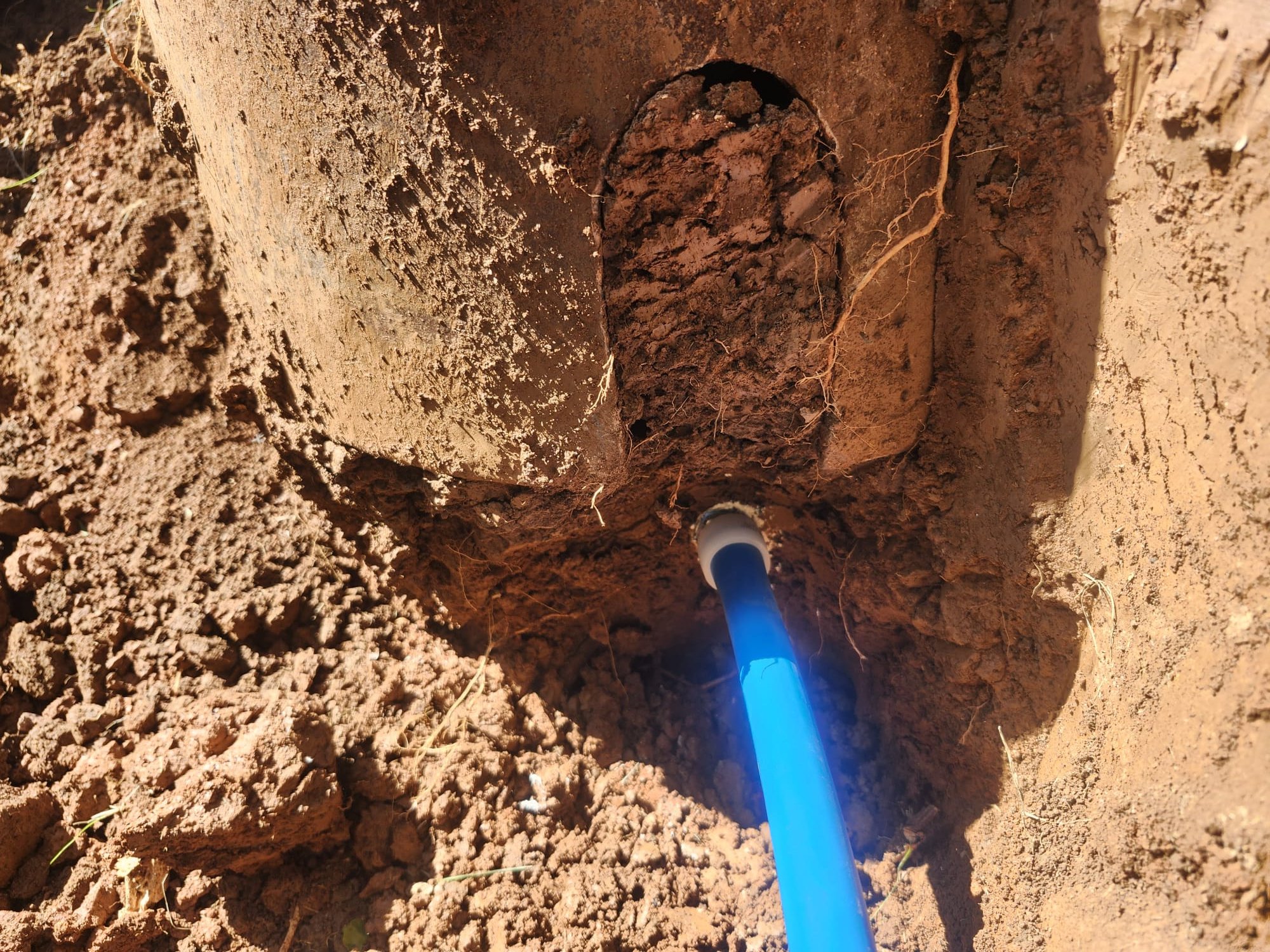 Installation of new blue pipe in trench