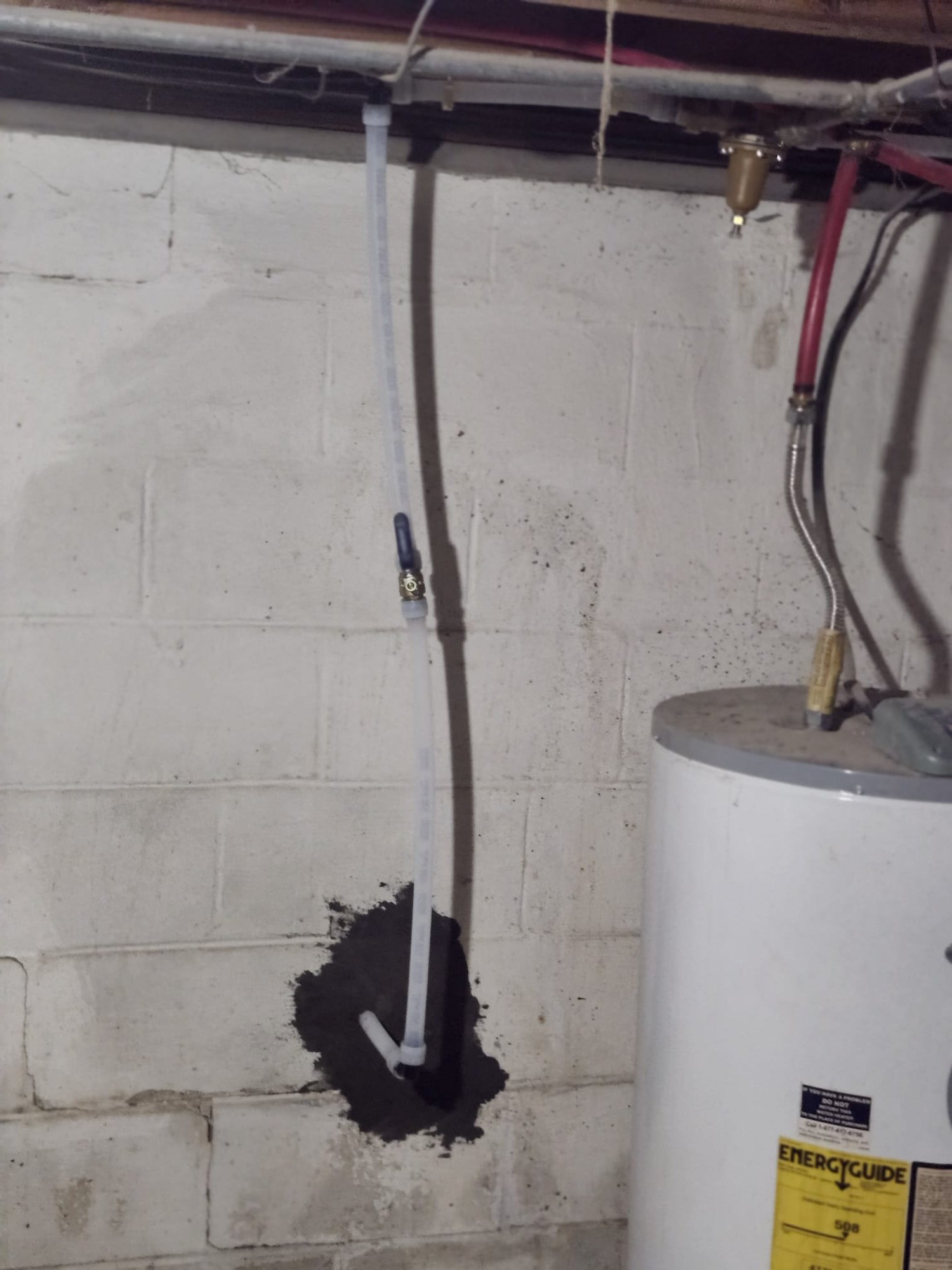 Freshly sealed foundation entry with new flexible line