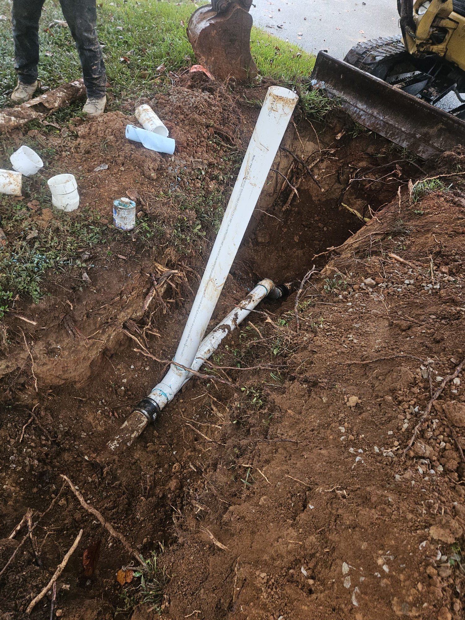 Plumbing accessories and freshly cut sections laid out before installation