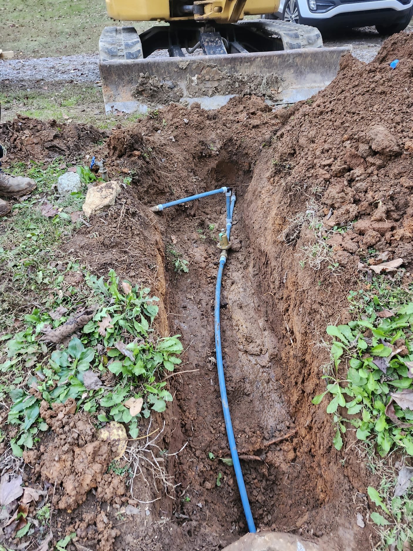 Newly installed blue PEX line in trench
