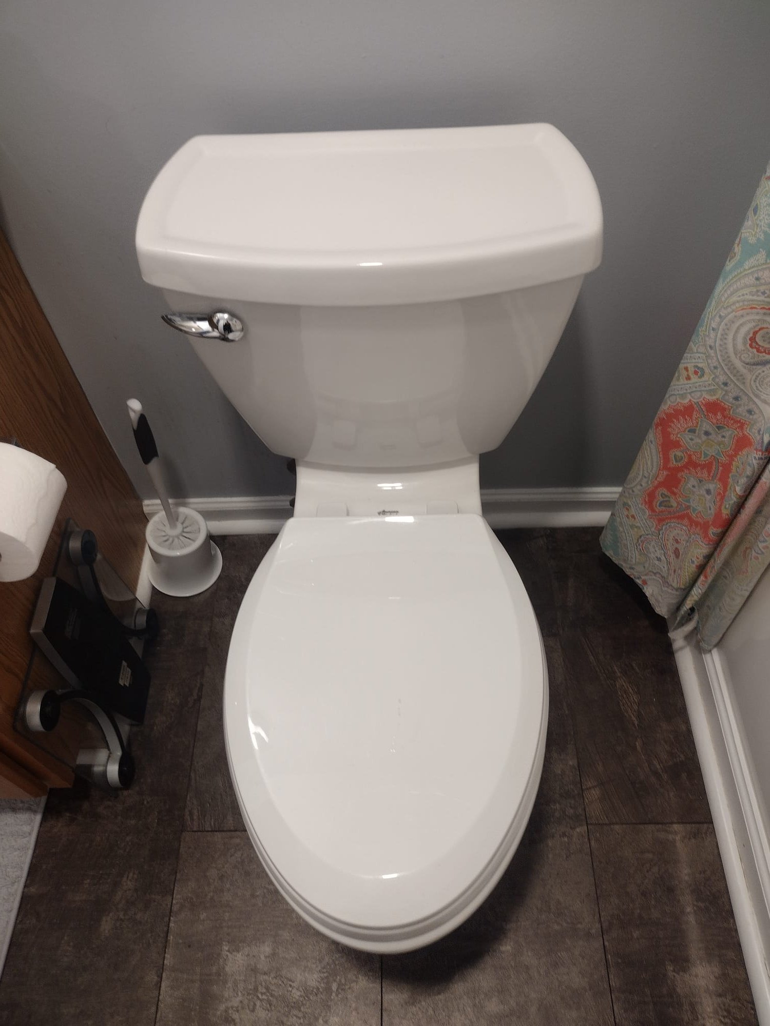 This image shows a clean and modern toilet installed in a residential bathroom. The toilet appears to be in excellent condition, with no visible signs of damage or leaks.