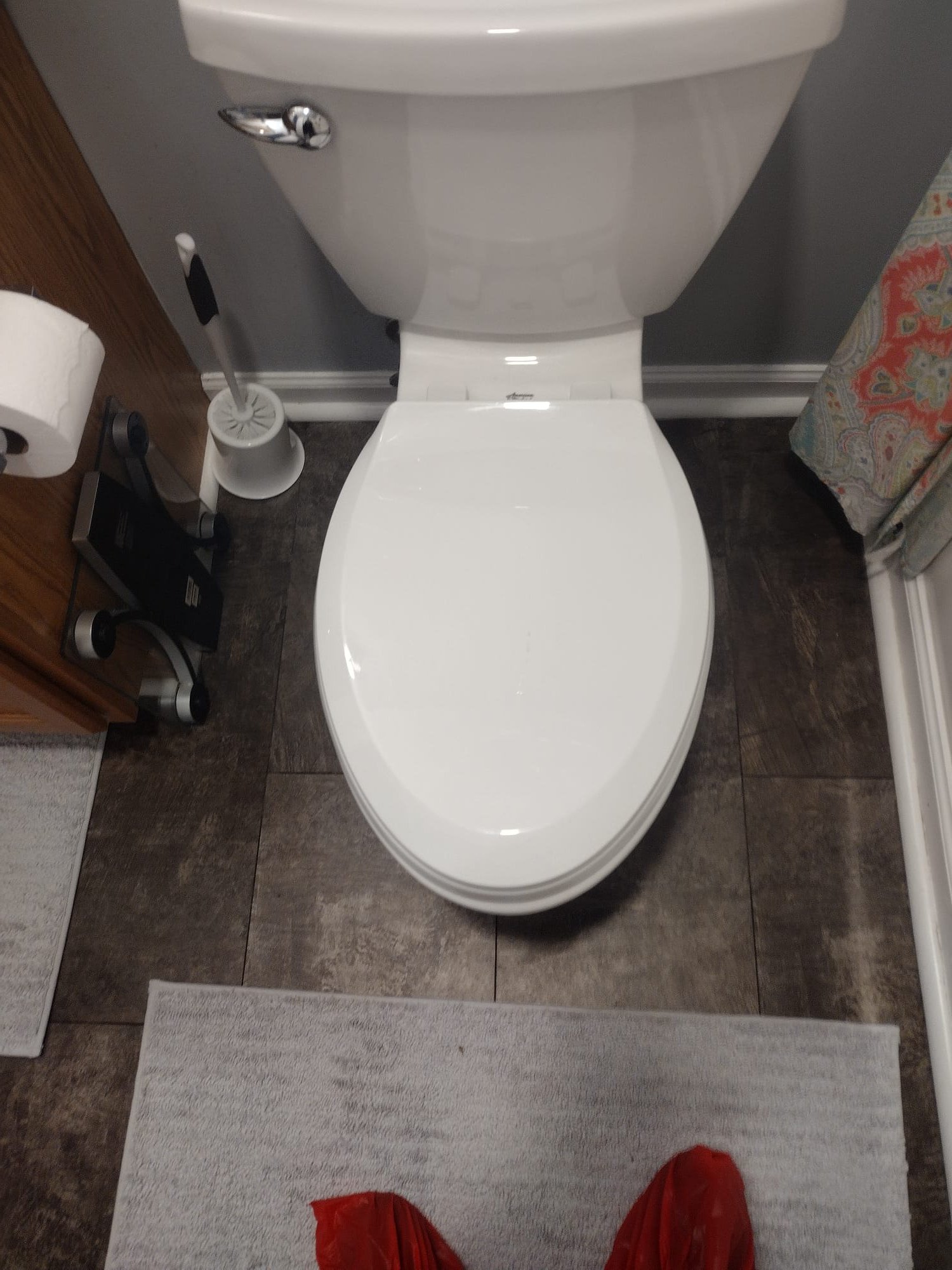 This image shows a clean and modern bathroom setup after a professional installation. The toilet and fixtures look new, and the surrounding area is tidy and well-maintained.