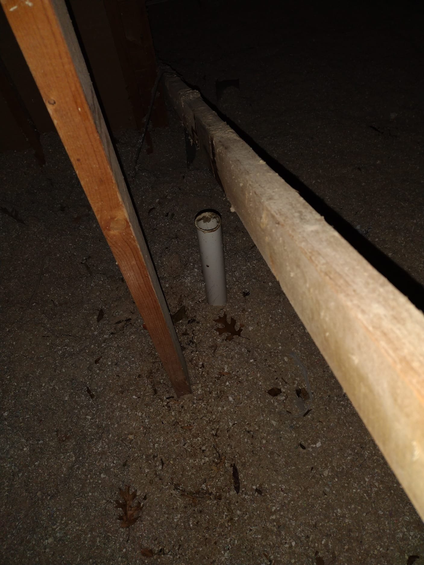 PVC pipe protruding in attic before cleanup