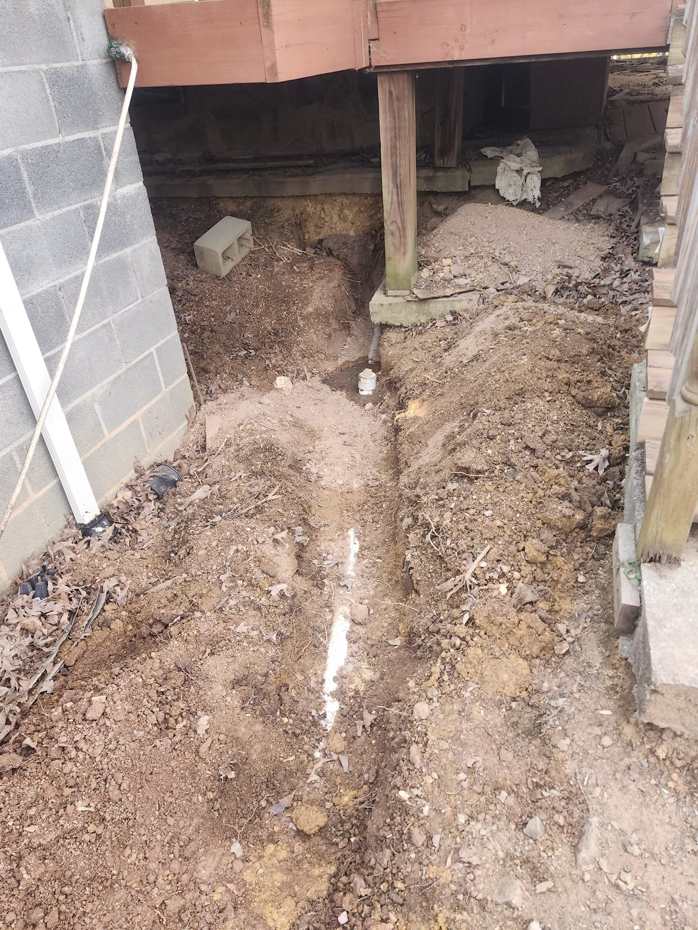 New plumbing trench beside house