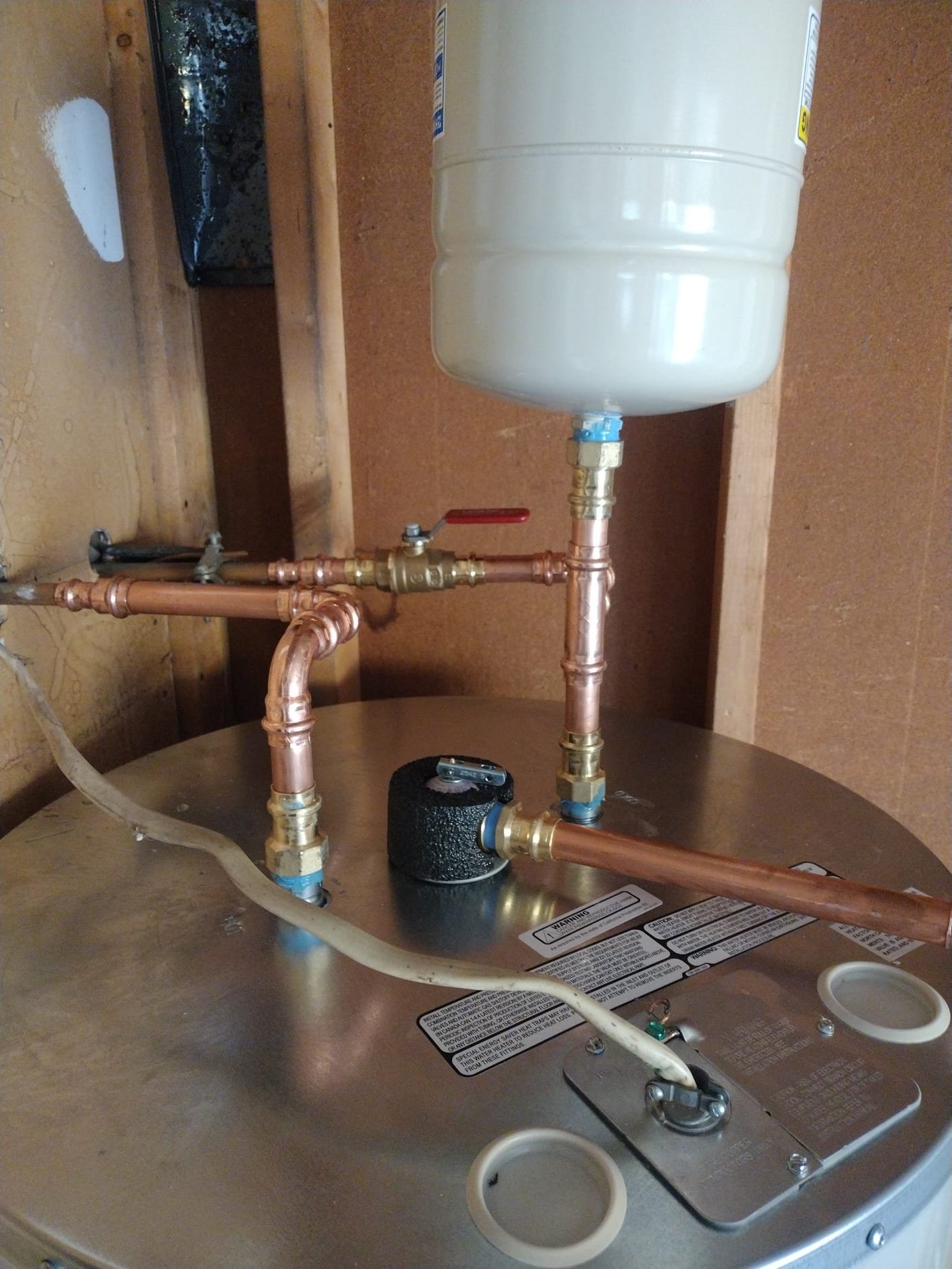 Top of water heater showing new plumbing components