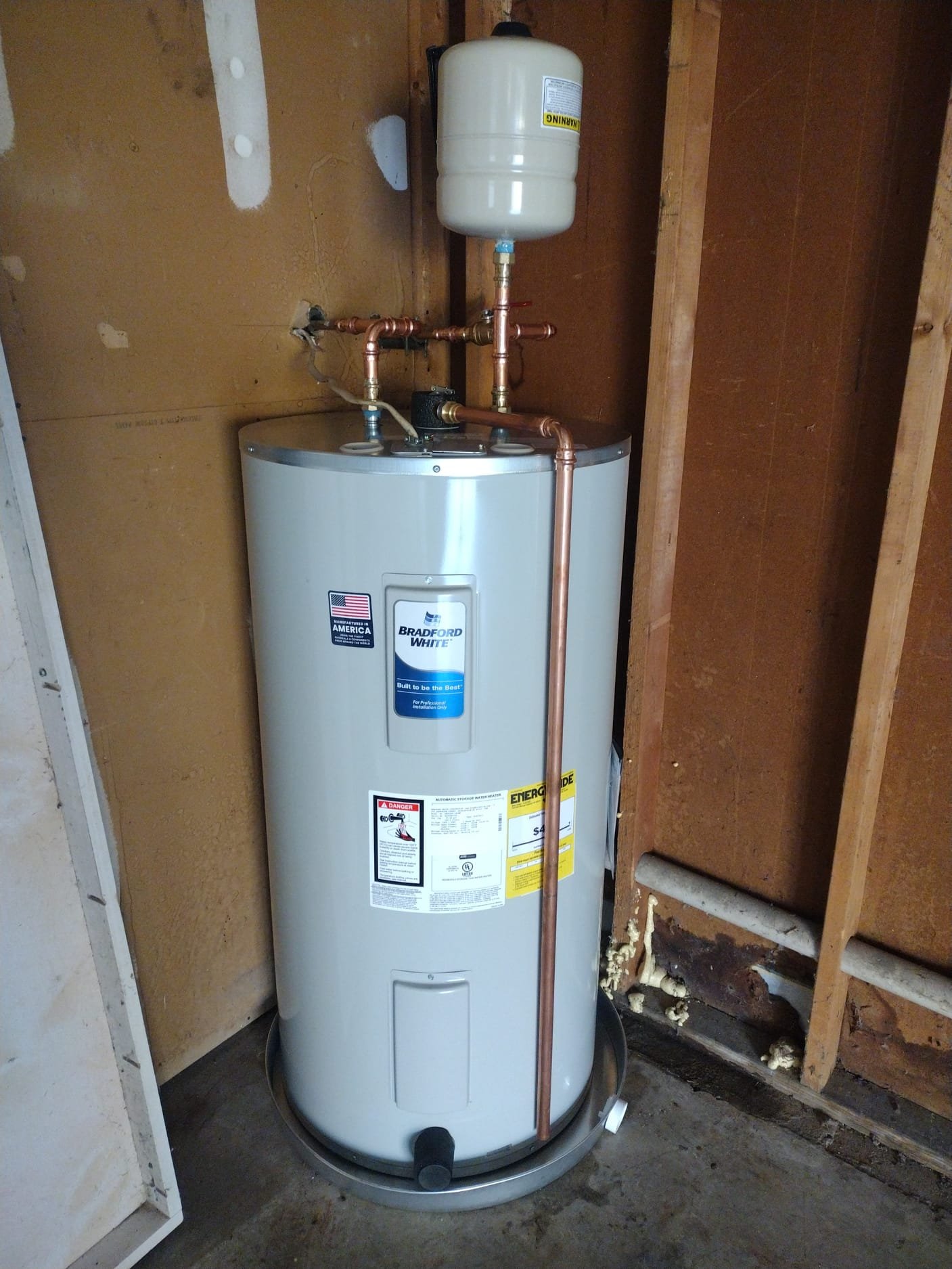 Newly installed water heater highlights clean copper piping and expansion tank