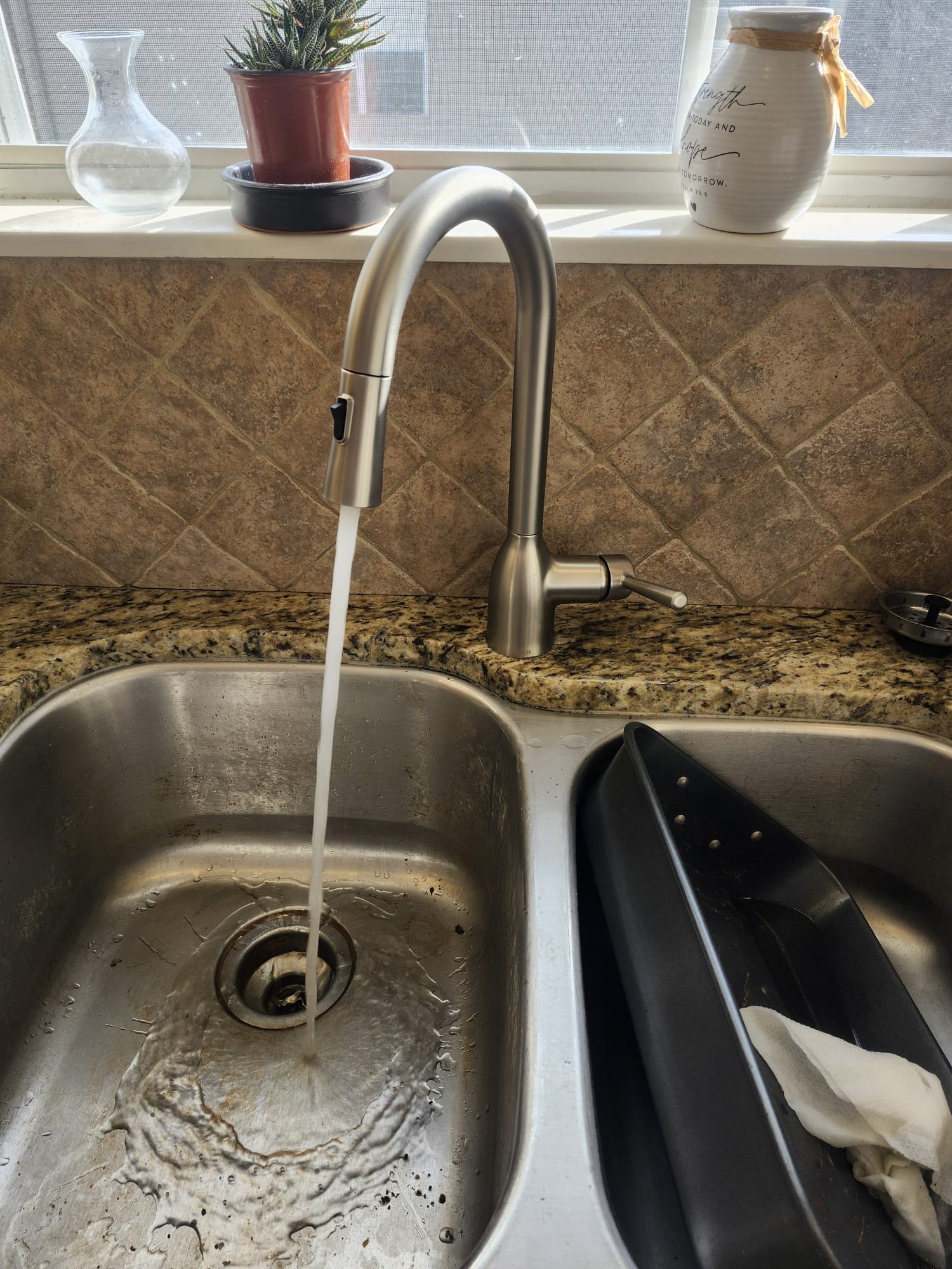 High-arc faucet in action with a strong, even water flow