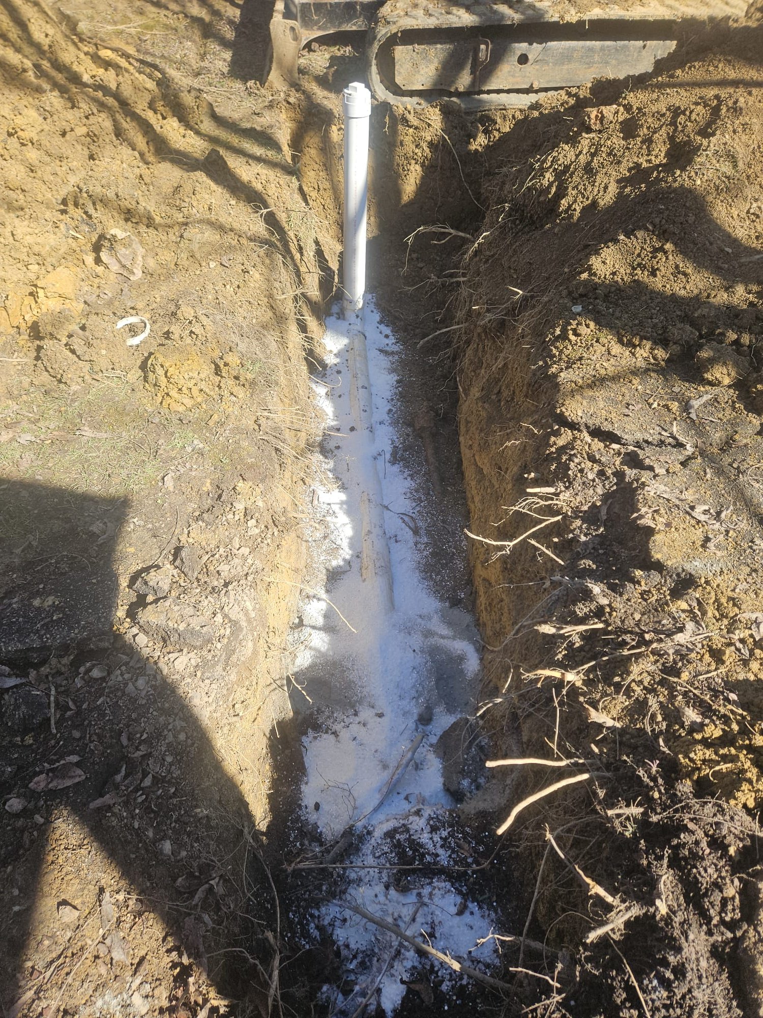 New PVC pipe with marking powder in open trench