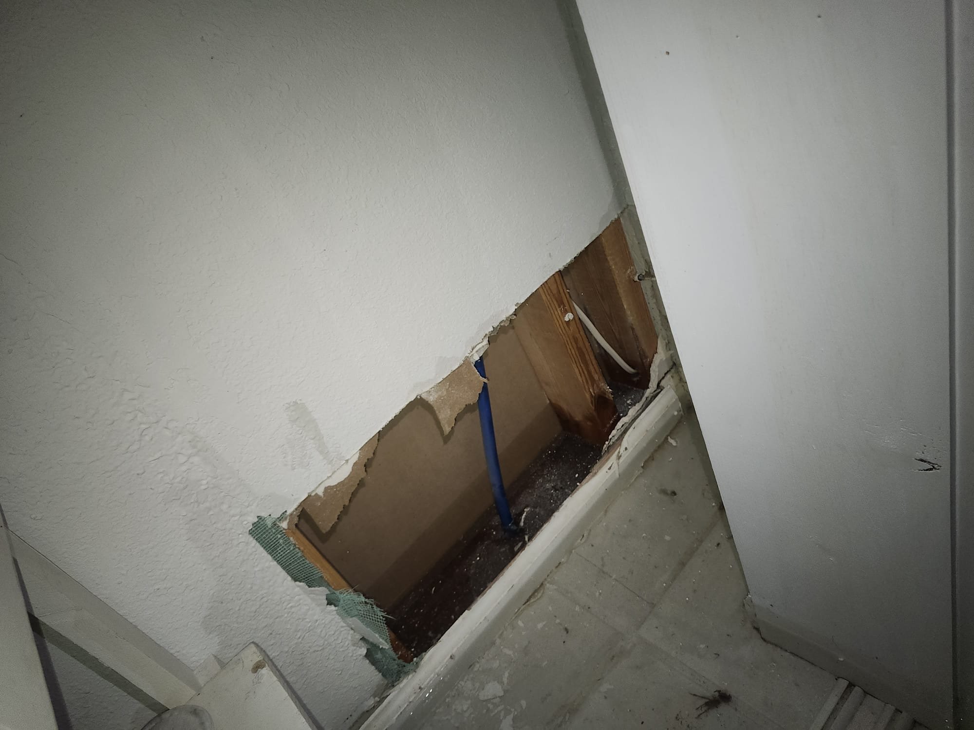 Inspection Cutout Showing Exposed Pipe