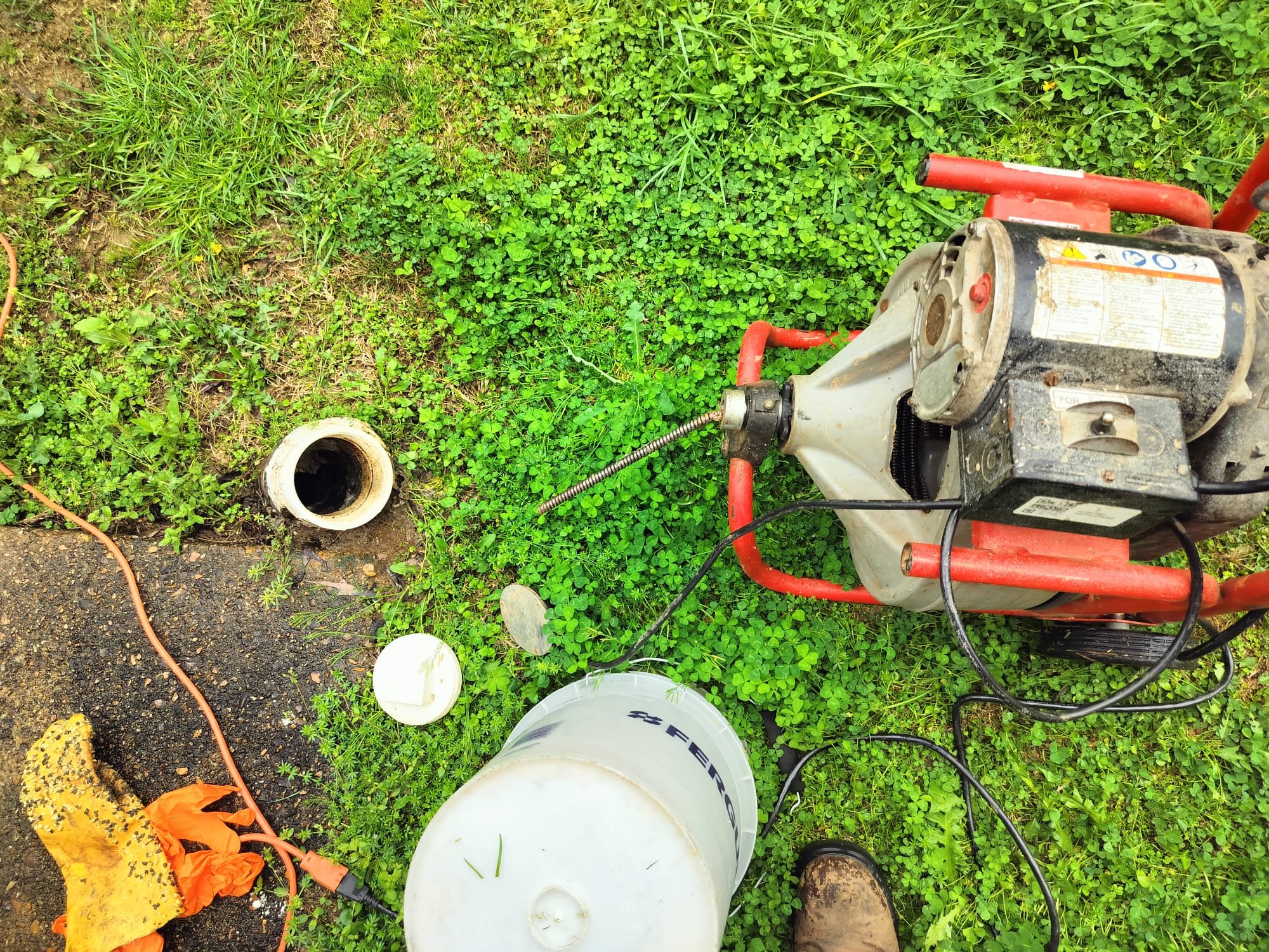 Plumber’s drain cleaning auger setup
