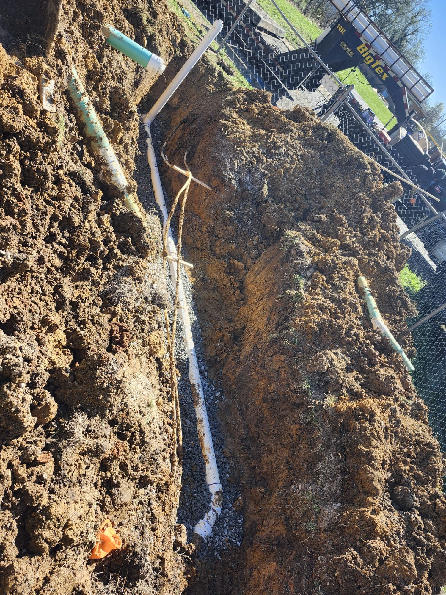New and old pipes side by side in a trench