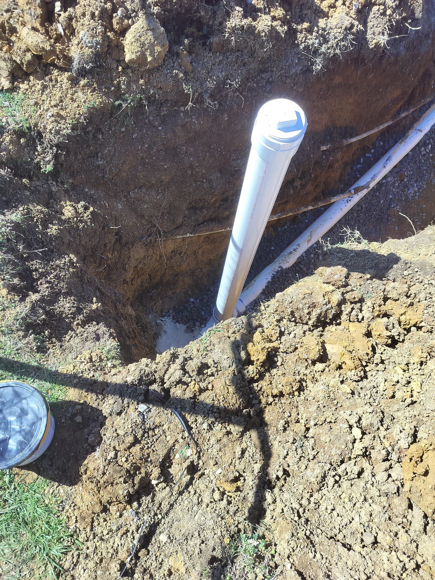 Clean-out pipe exposed in a trench