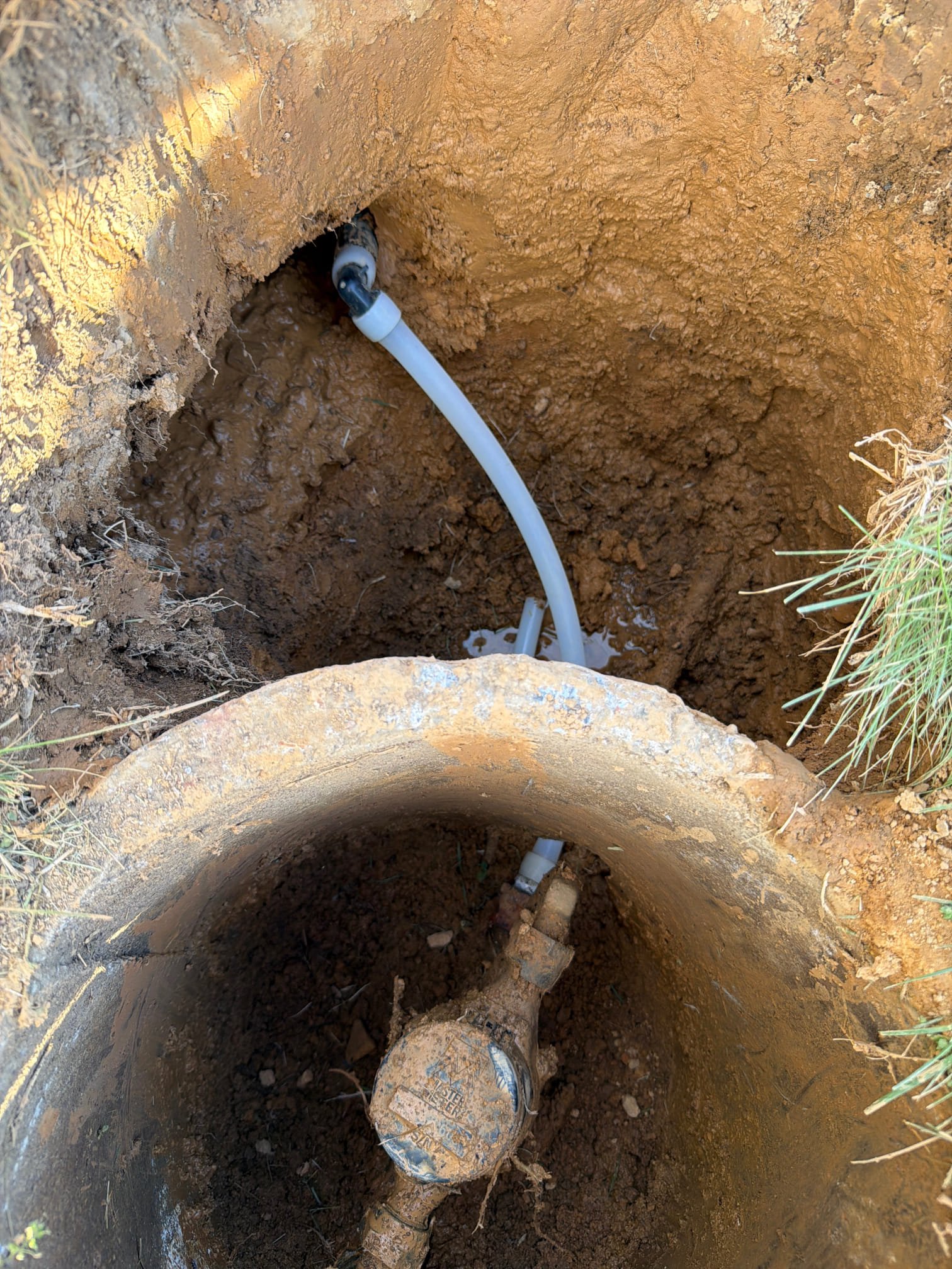 Water meter assembly showing new PEX connection