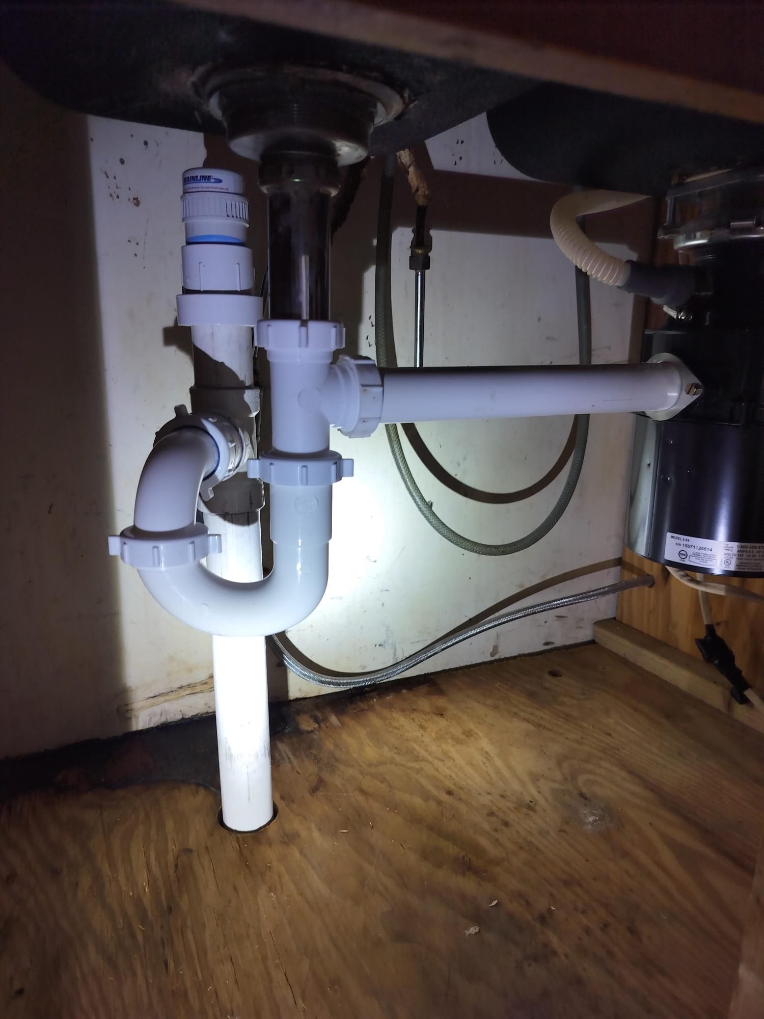 Newly installed drain assembly under a kitchen sink