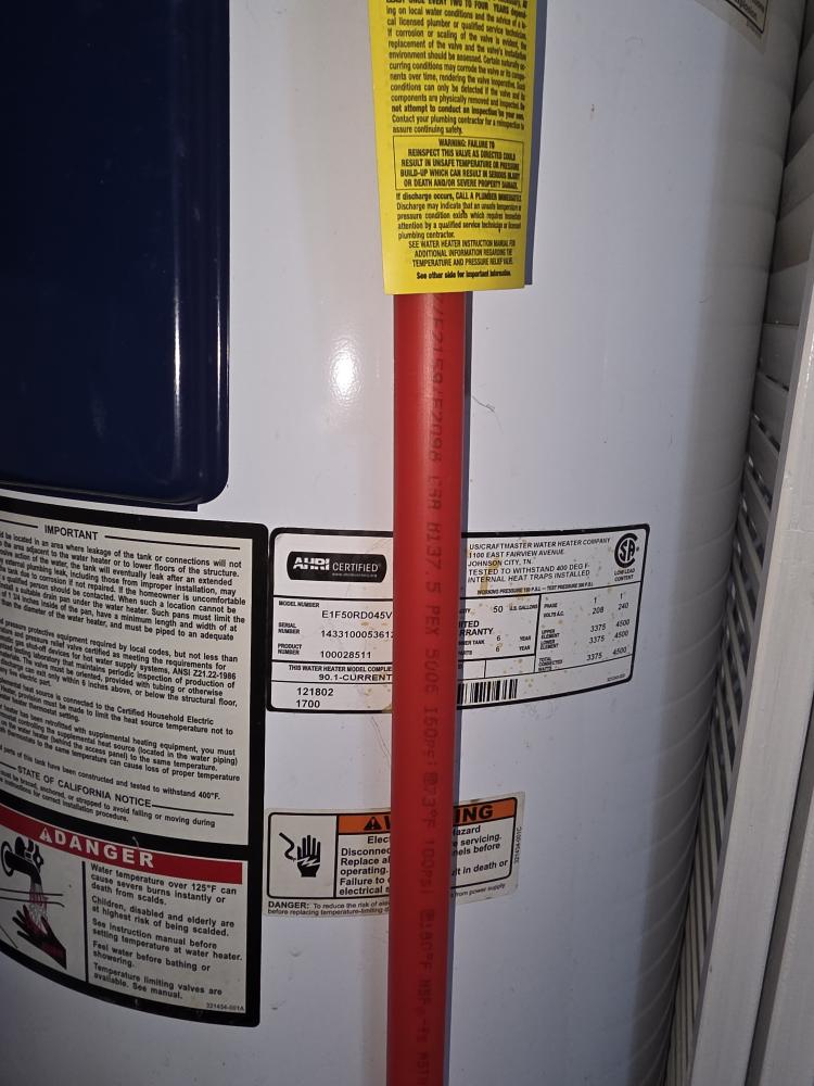Close-up of PEX connection on a water heater, showcasing new materials