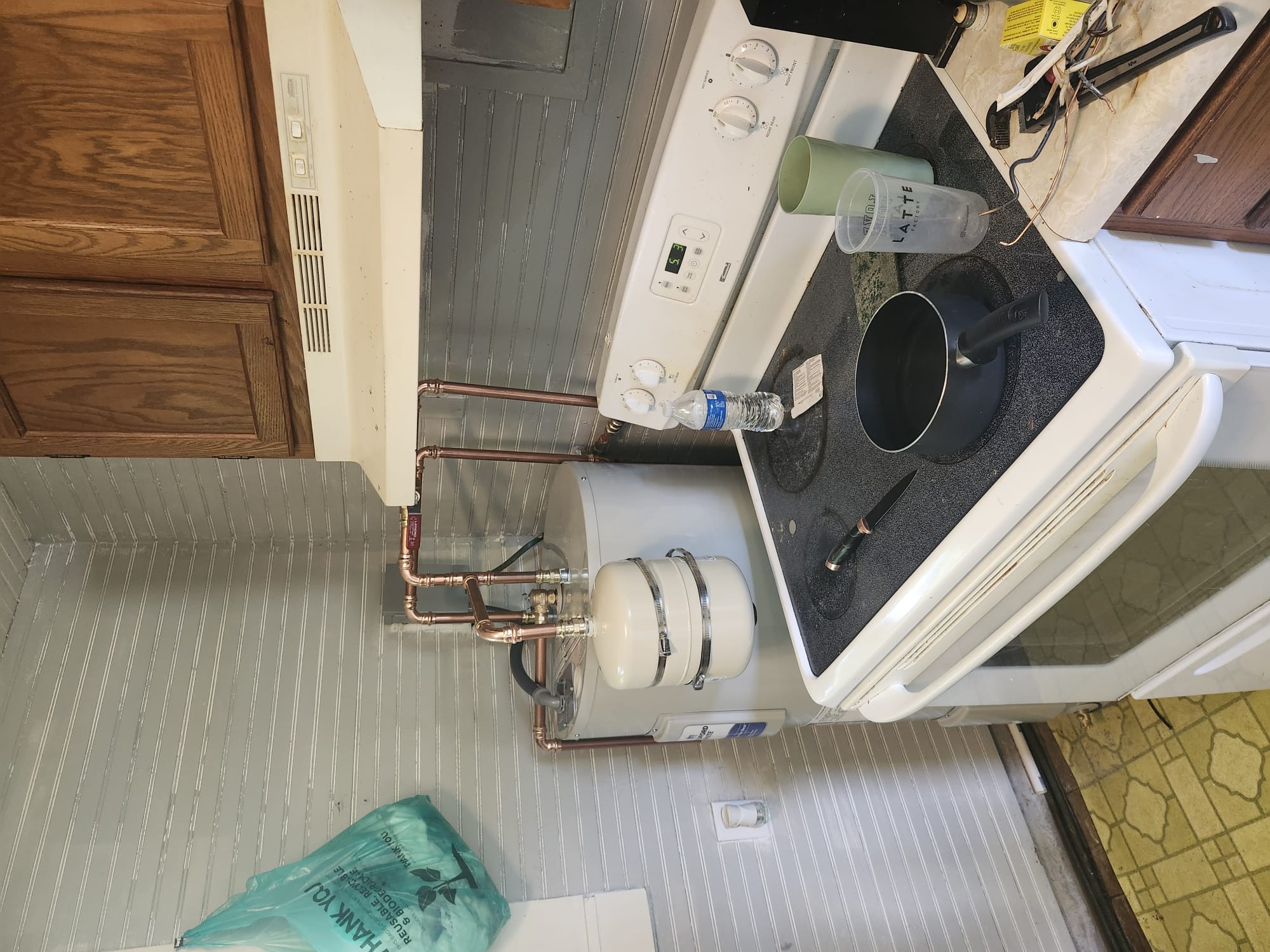 Shiny new copper pipes and water heater installation corner