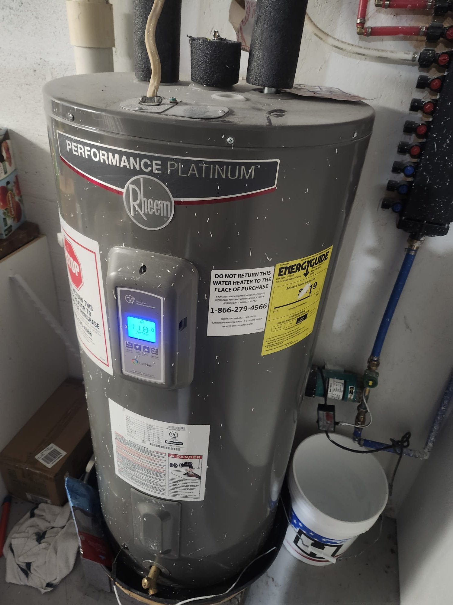 Rheem Performance water heater in a tidy utility area after maintenance