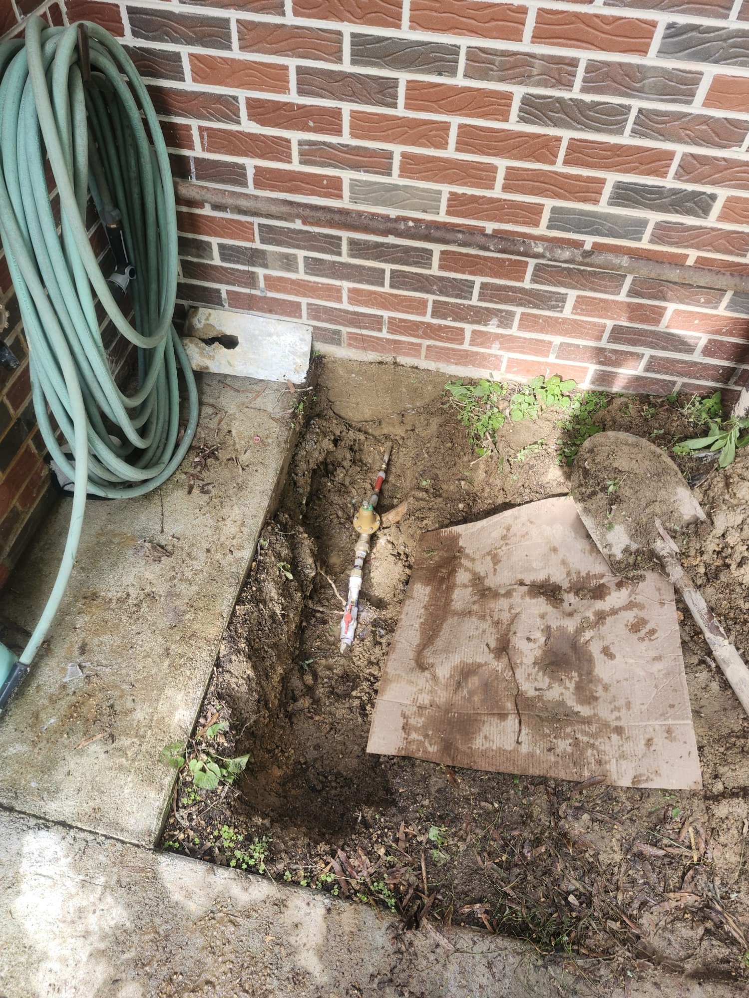 Newly installed ball valve in trench after repair.