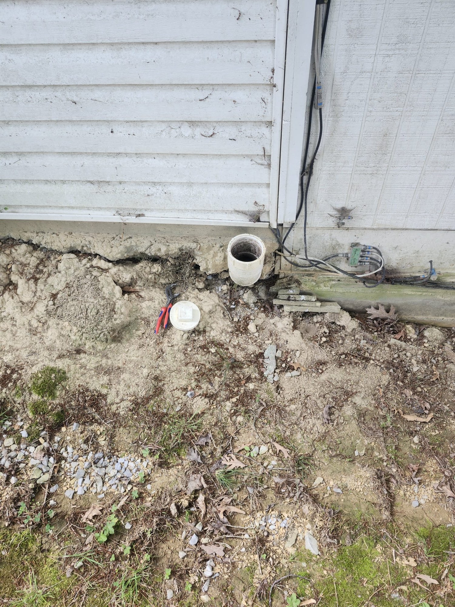 Open exterior cleanout used during a plumbing inspection