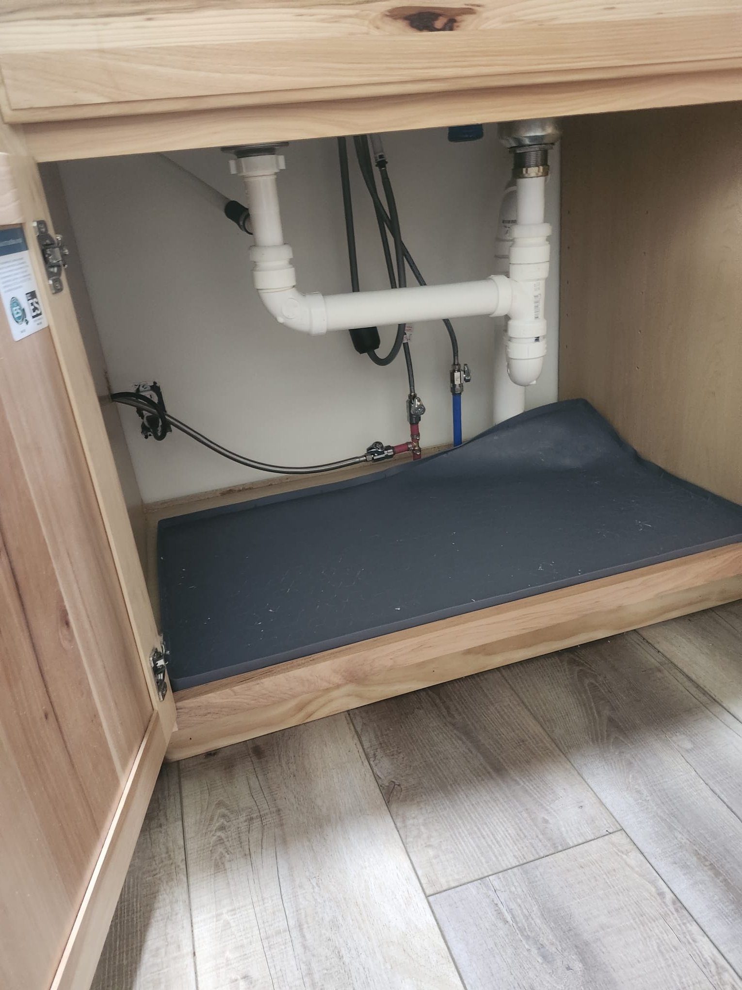 Finished under-sink drain piping after plumbing work